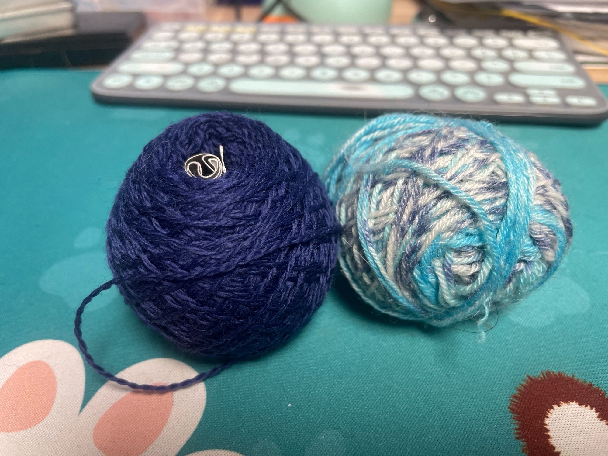 The self-striping/patterning blues & white yarn and navy blue yarn used for the Mosasaur‘s body. Fins & tail are this navy and a slightly darker one.