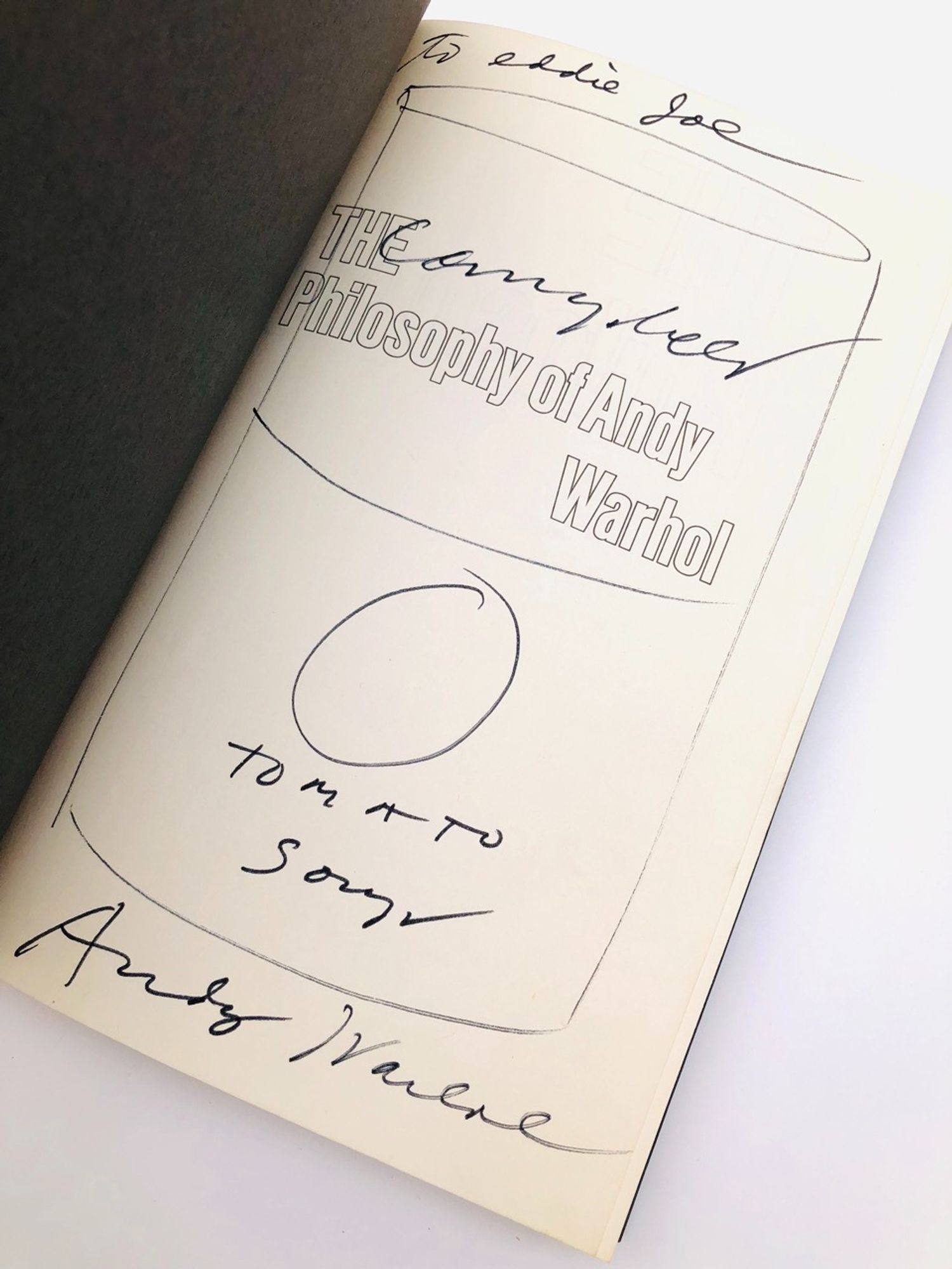 The half-title page of The Philosophy of Andy Warhol. It shows his inscription which includes an original drawing of a Campbell's Tomato Soup can.