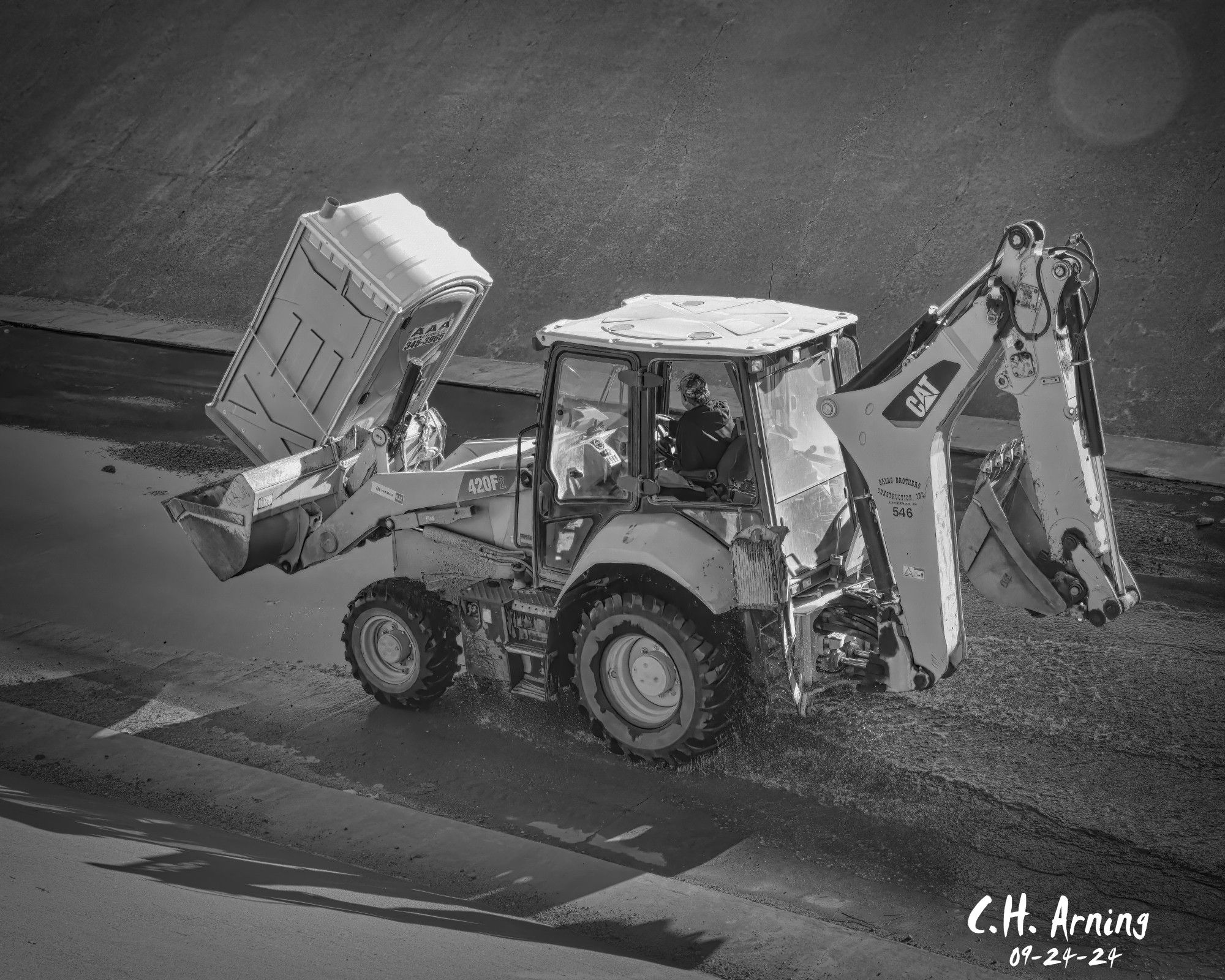 Walking the North Channel Trail in a loop around the city, I found a crew still hard at work on the channel. My 09/24/24 postcard captures a CAT tractor delivering much-needed relief—a port-a-potty for the busy workers.