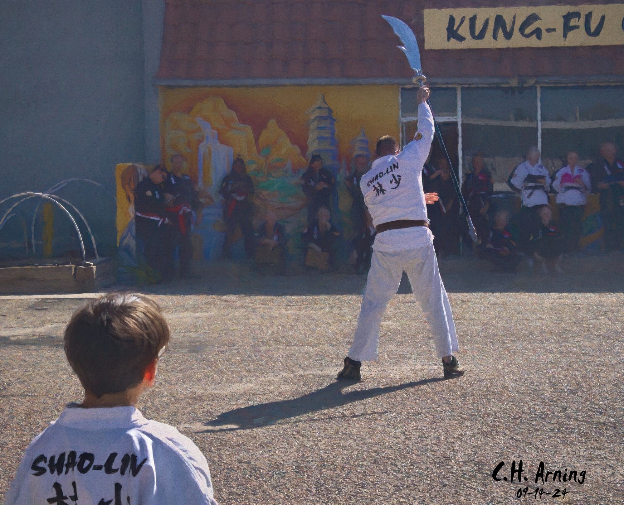 My 09/14/24 postcard captures a moment from a martial arts demonstration we stumbled upon along Gibson. Under the bright sun, students, instructors, and judges watched each move with focused intensity, a quiet energy in the air.