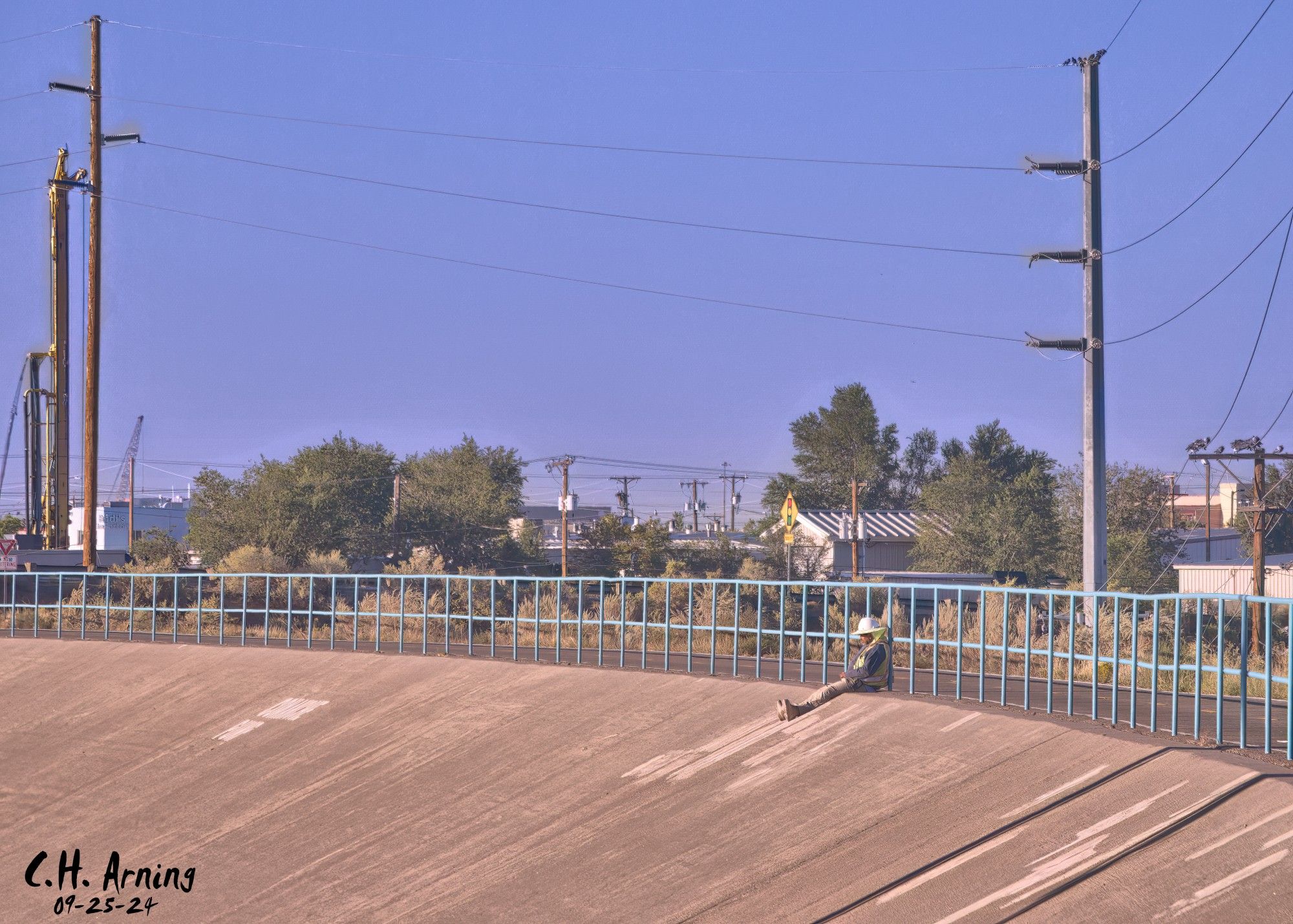 Taking a moment from pouring cement on the North Channel project, my 09/25/24 postcard captures a lone construction worker sitting quietly on the slope, soaking in a moment of stillness amid the day’s demands.