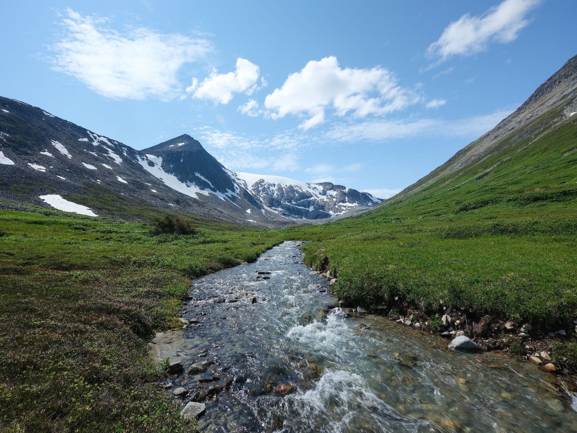 A glacial stream under blue(ish) skies, in far NW BC