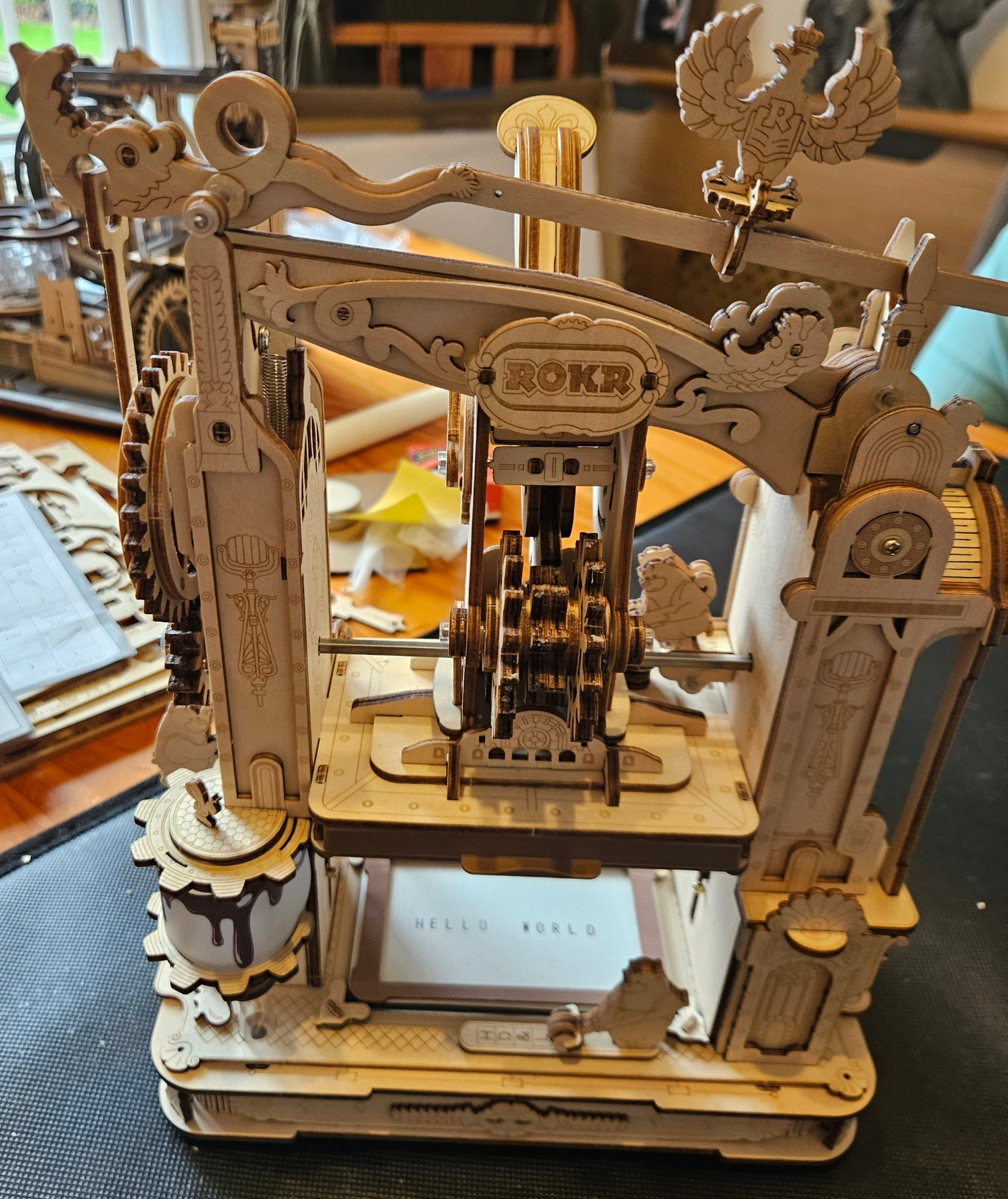 A model printing press with 'Hello World' printed on a small card