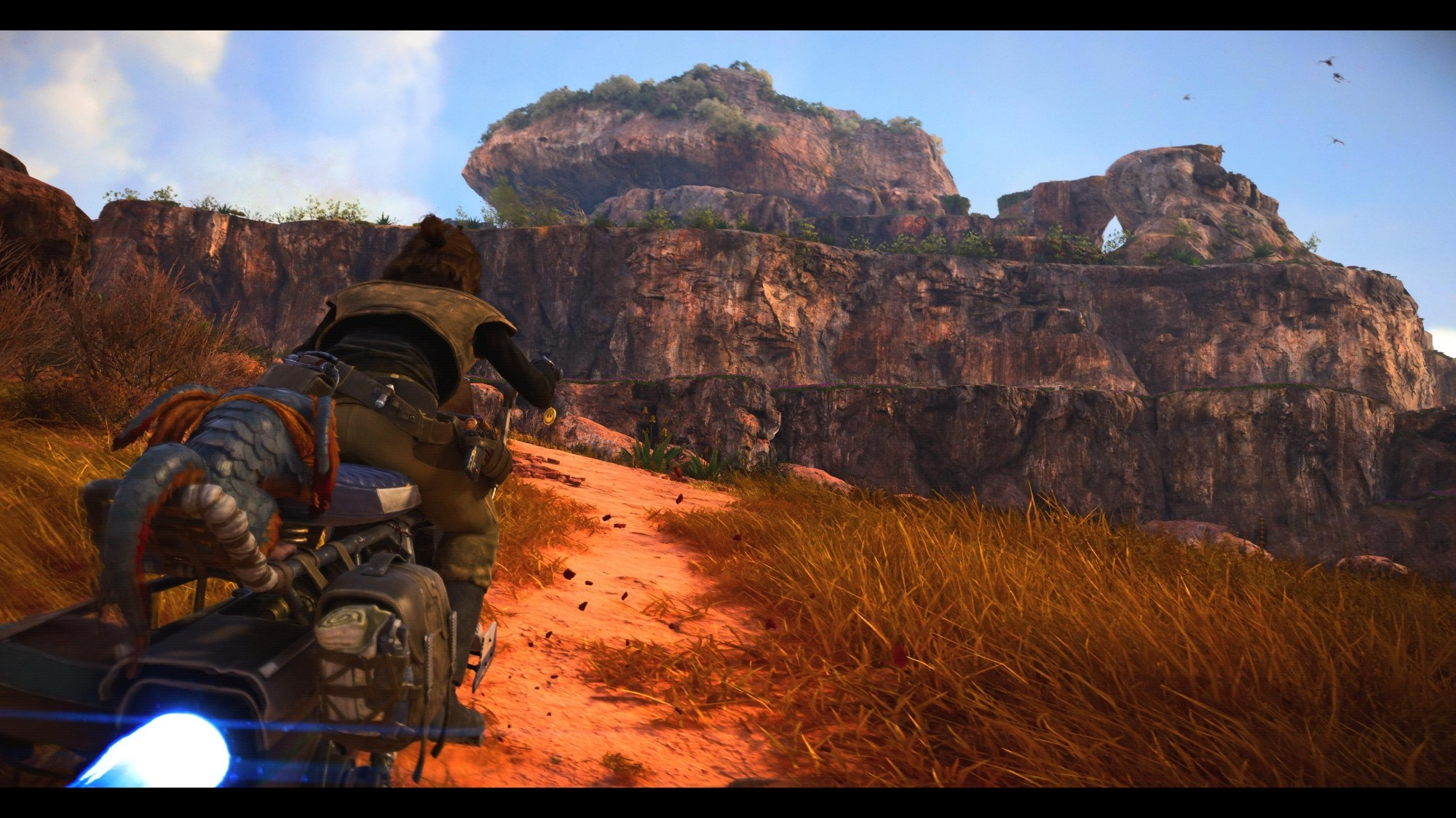 Kay and Nix roar along one of Toshara's open dirt roads on their speeder bike, Typhon's Rock rises in the distance.