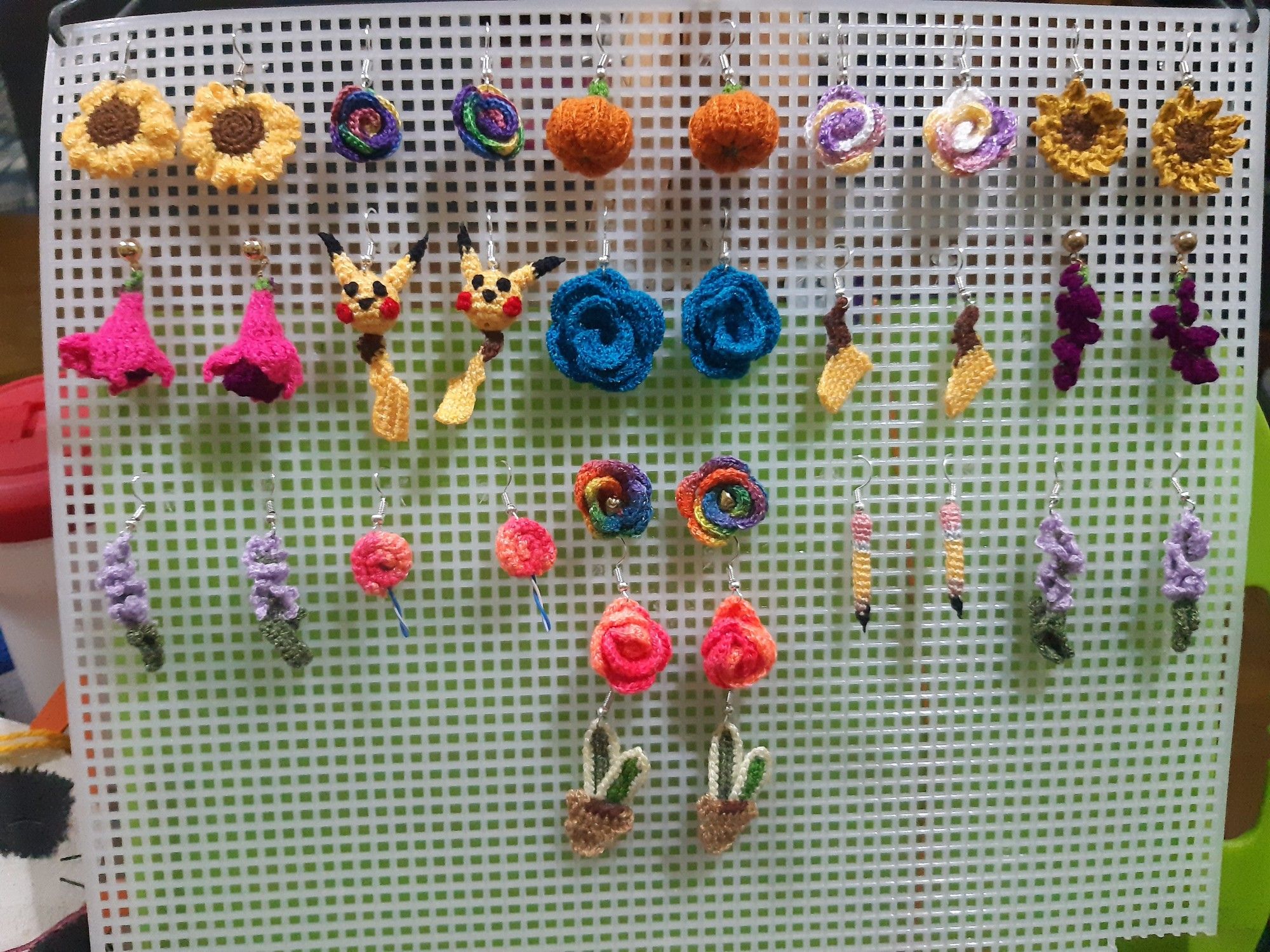 Earrings made by hand in crochet, inspired in flowers: sunflowers, lavender, roses, fucsias, wysteria, snakeplant and pumpkins, also objects like pencils and lollipops and 2 inspired in pilachu, tails and head with tail