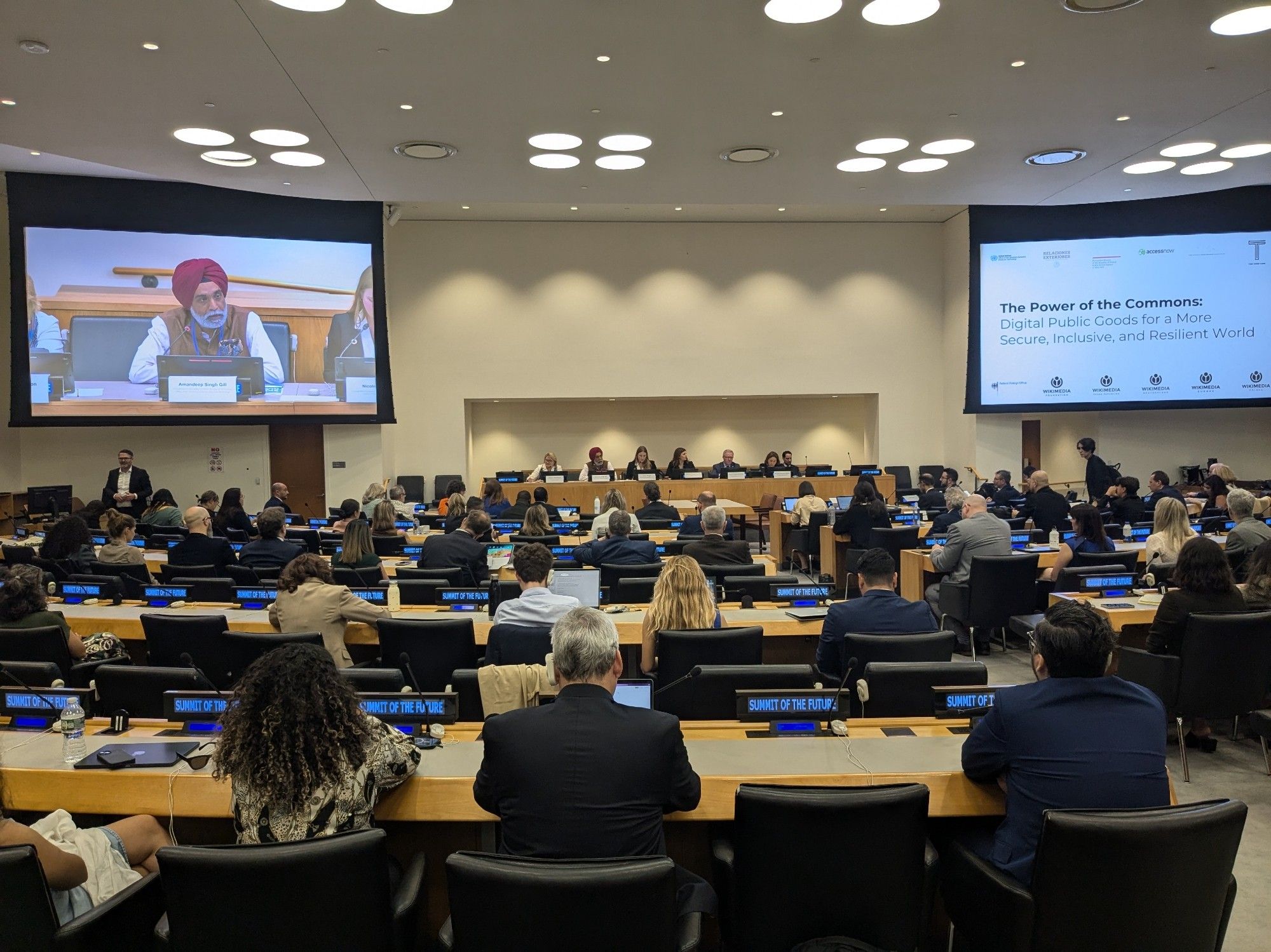 UN HQ conference room facing a panel of speakers.