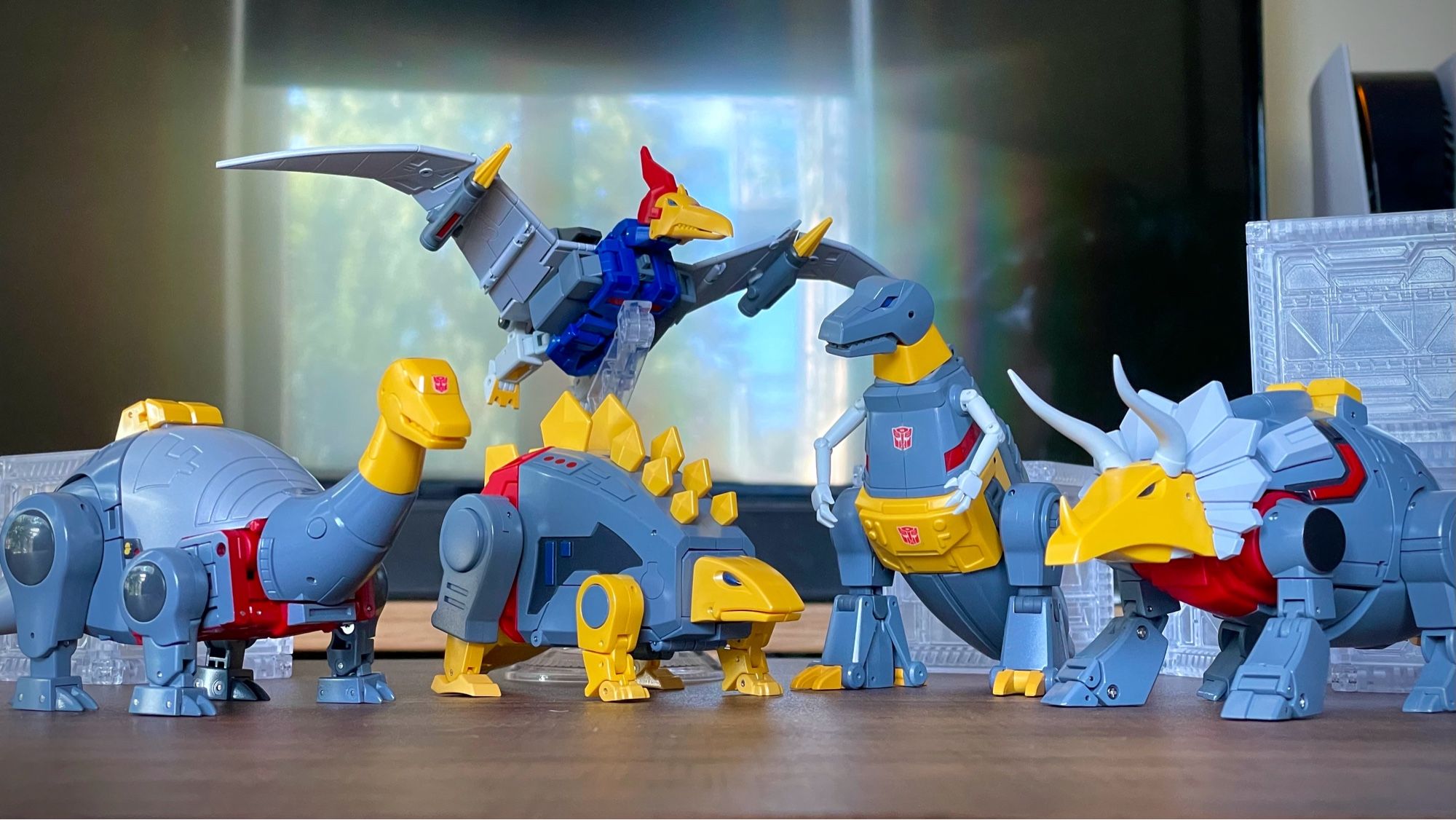 Group of small figures of Transformers characters the Dinobots.