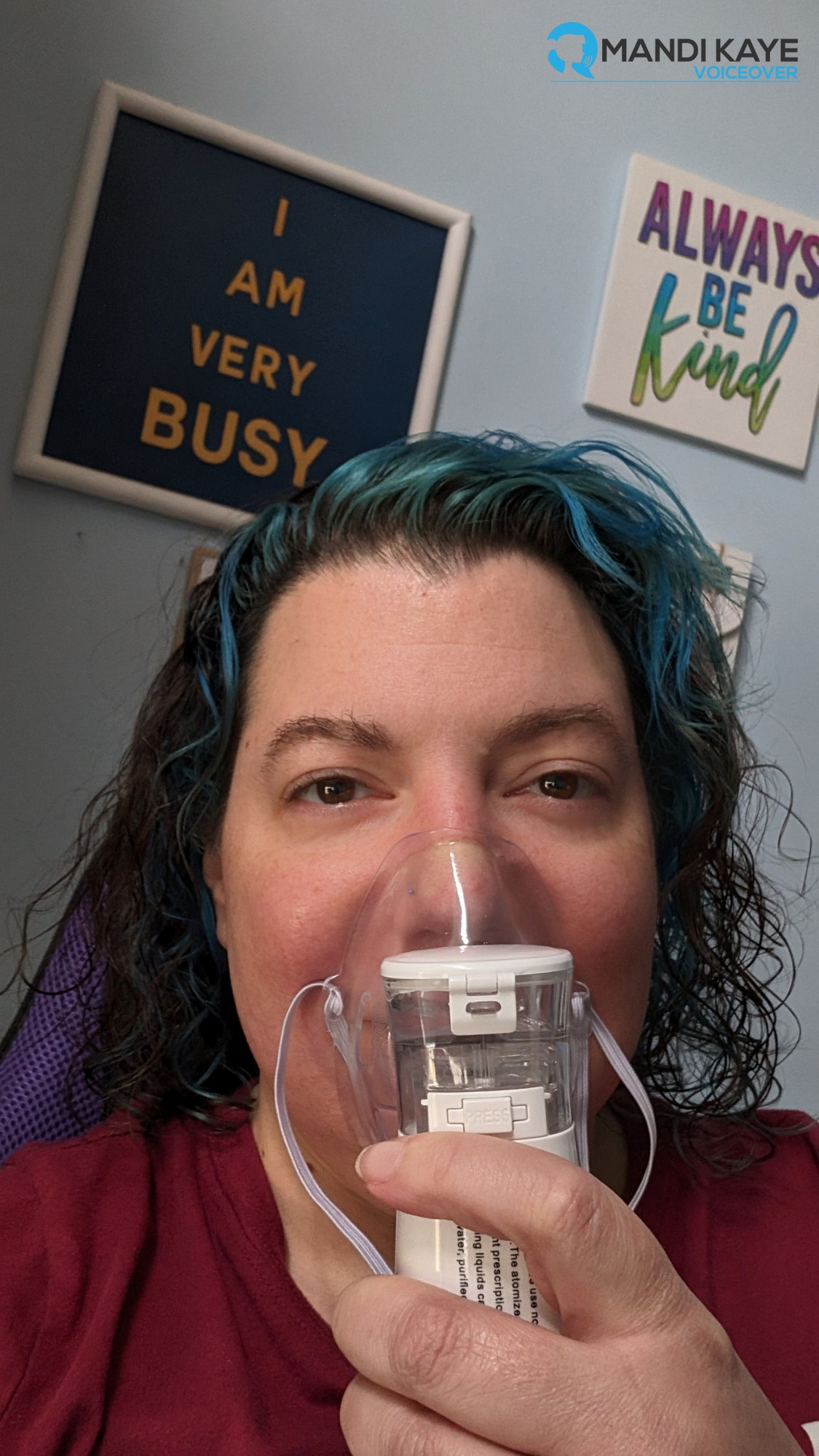 An image of me holding a portable nebulizer to my face.