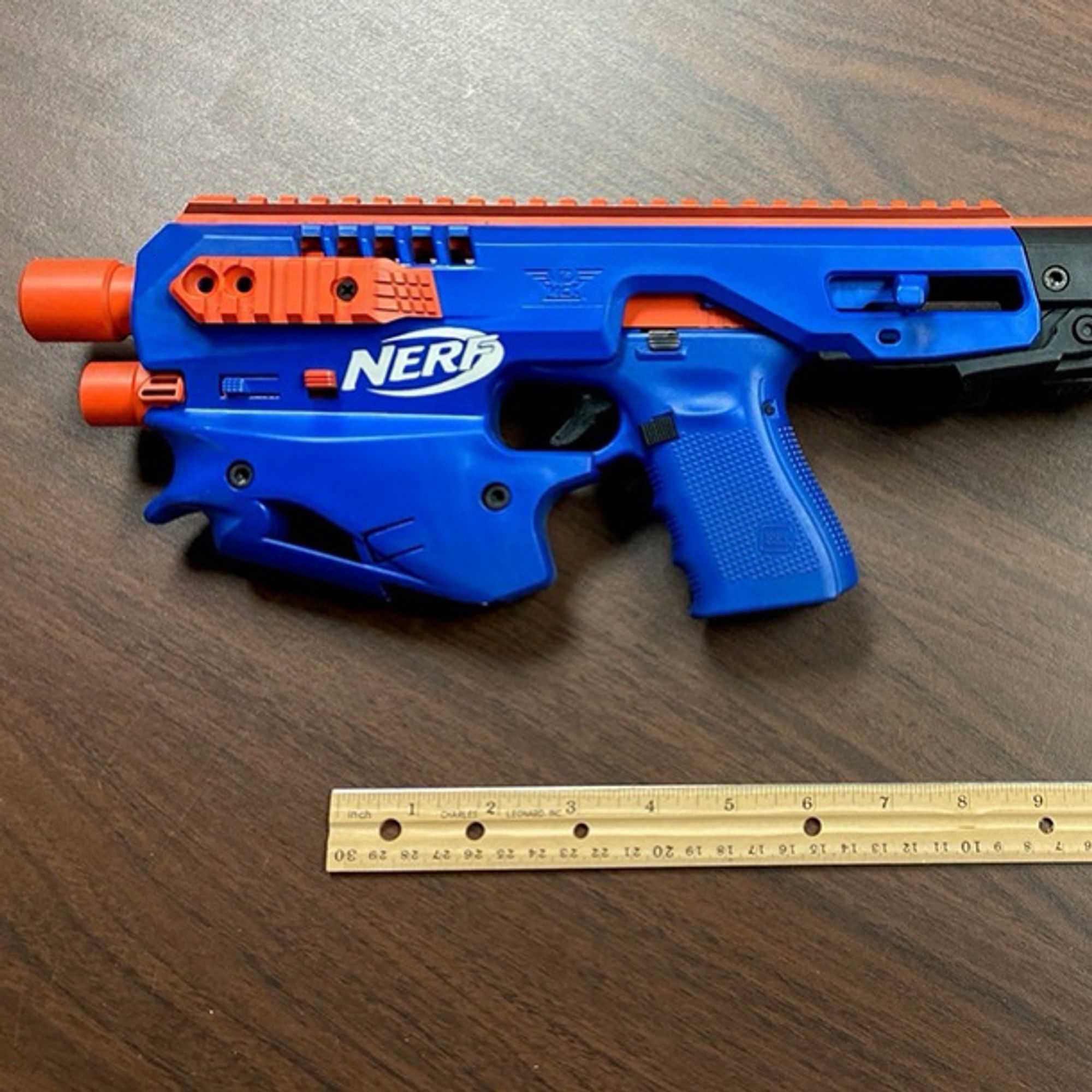 blue and orange firearm made to look like a nerf gun