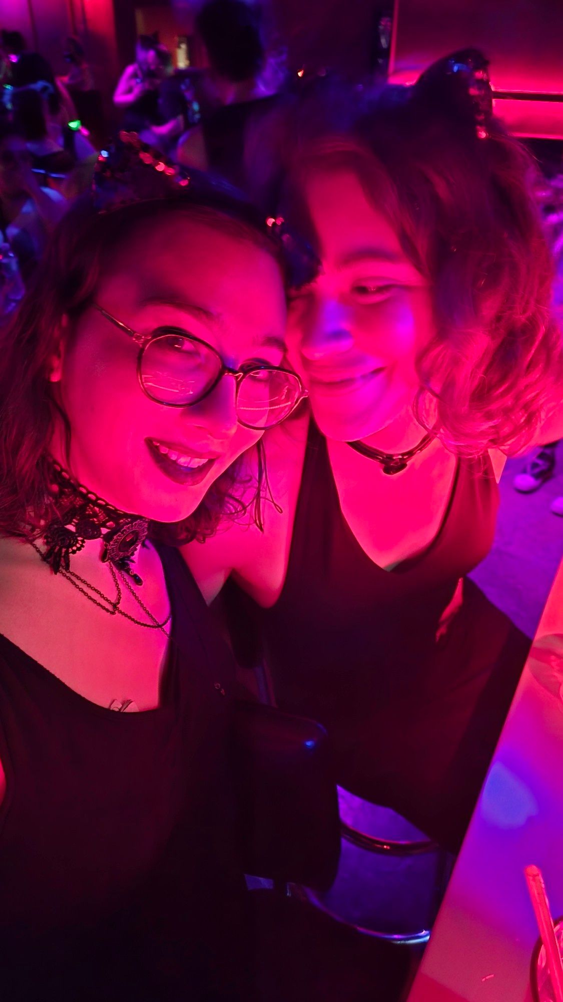 two girls in cat ears and dresses, lit bisexually