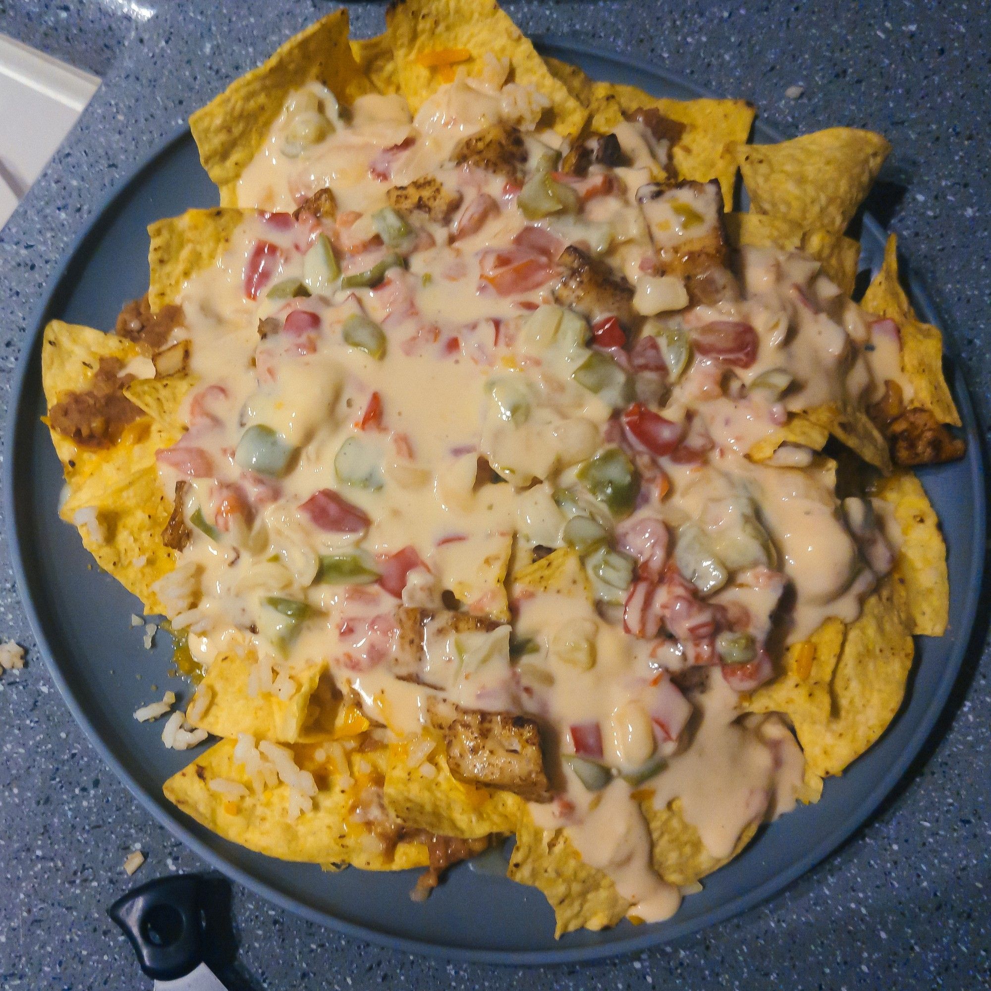 tex mex nachos with cheese, homemade chili con queso and lime-cilantro chicken