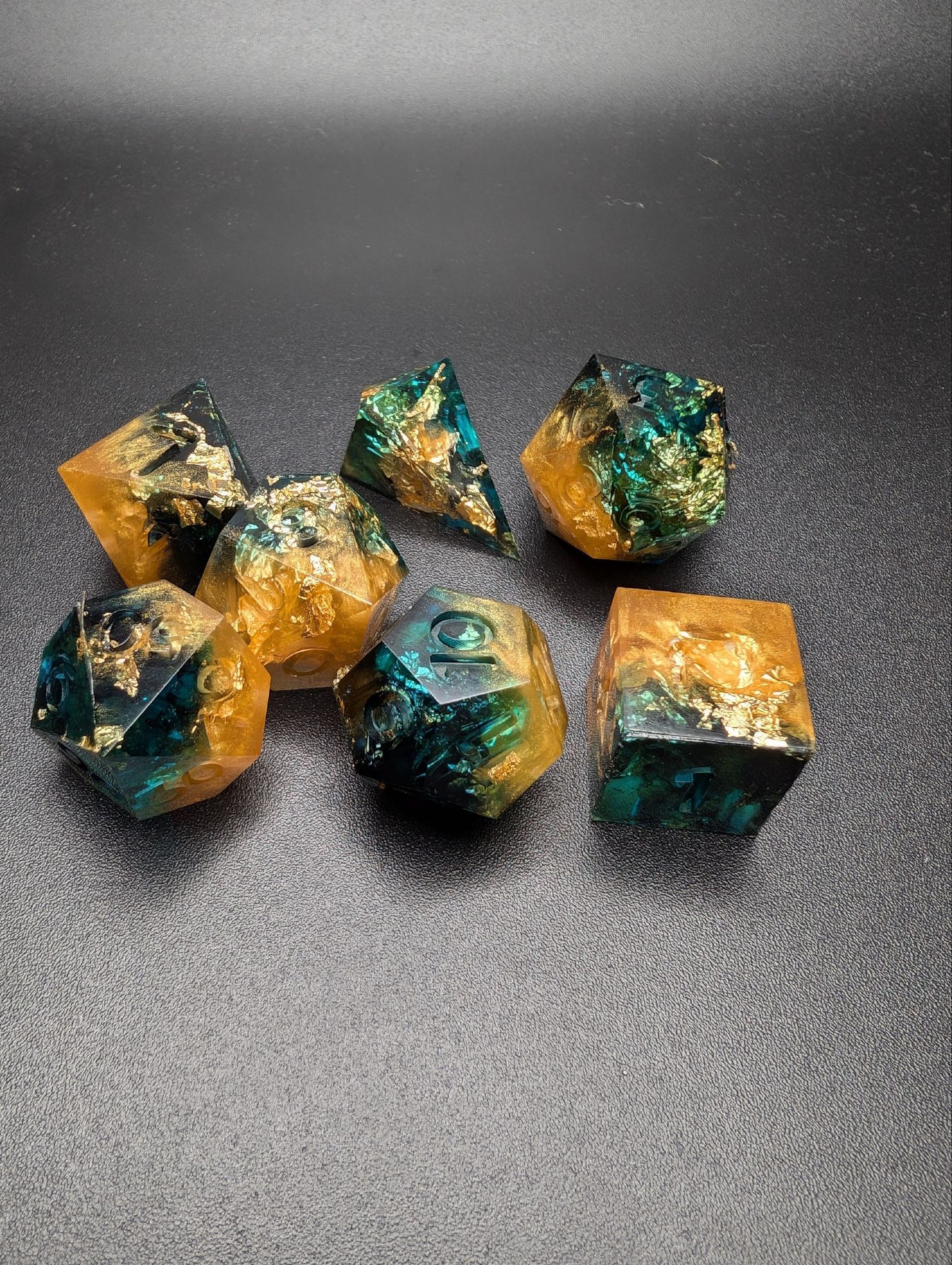 dark blue and gold dnd raw dice set fresh out of a mold