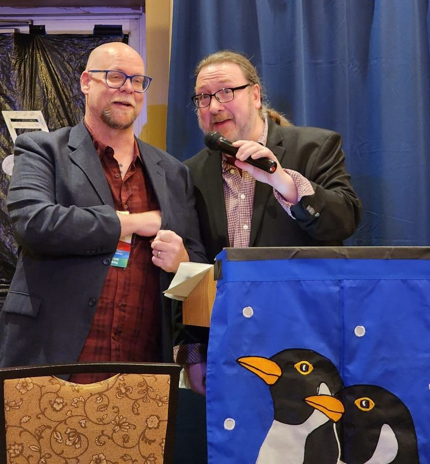 photo of Adam English and Rand Bellavia accepting their induction into the Filk Hall of Fame. 

Photo by G David Garland