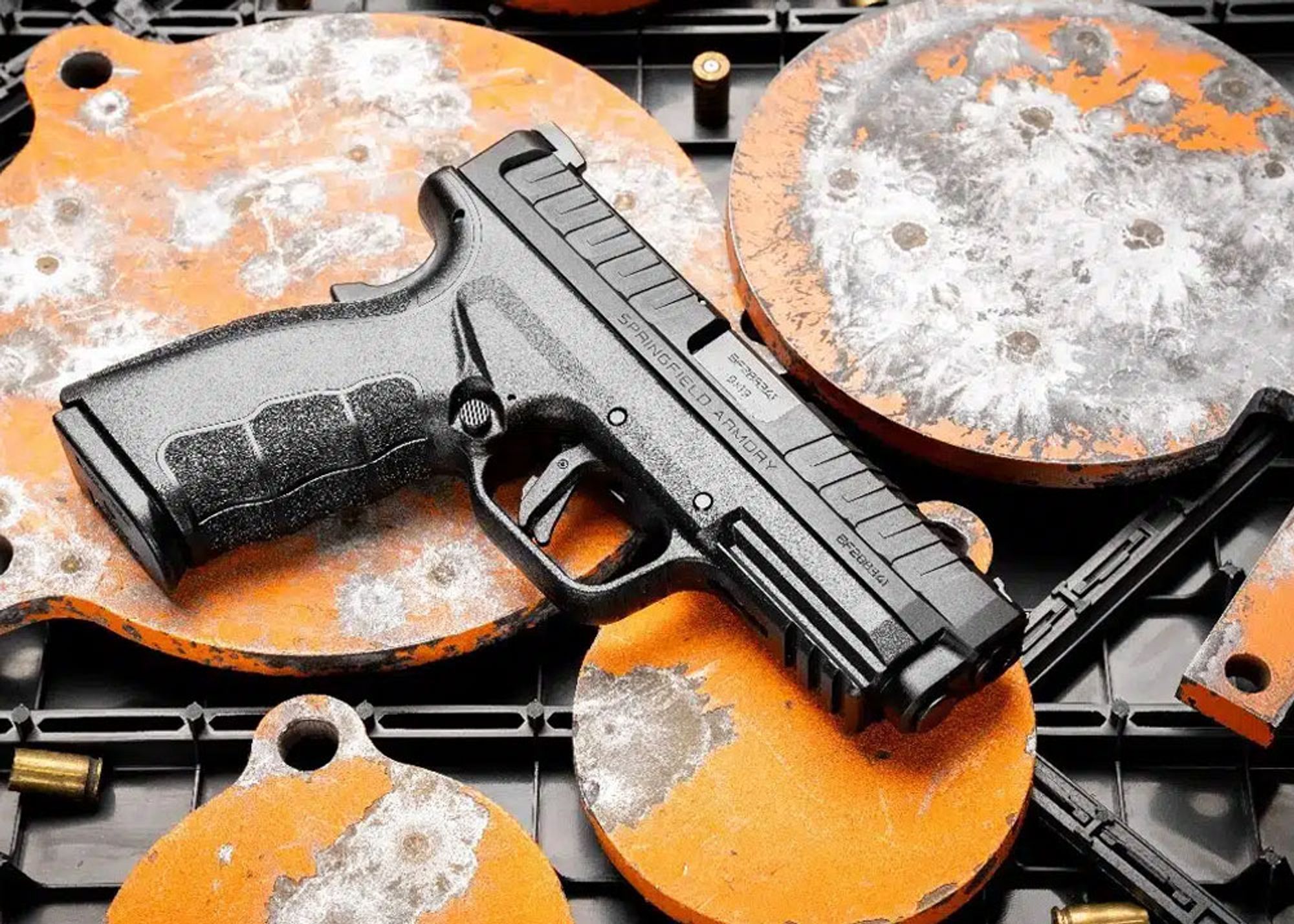 Springfield Armory Mod.3 OSP 9mm pistol lying on orange-coloured metal plates