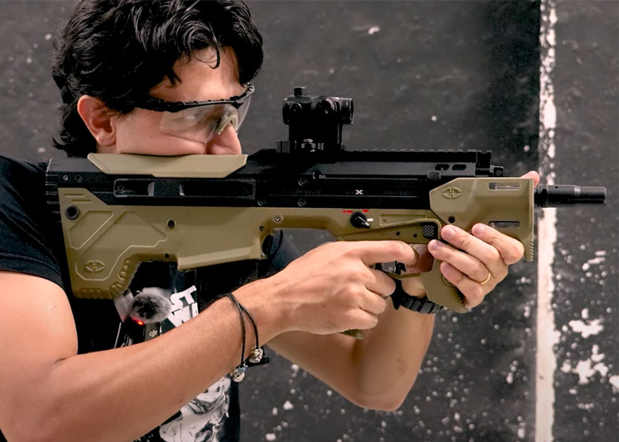 A man wearing protective glasses firing the Silverback MDR-X Micron airsoft rifle