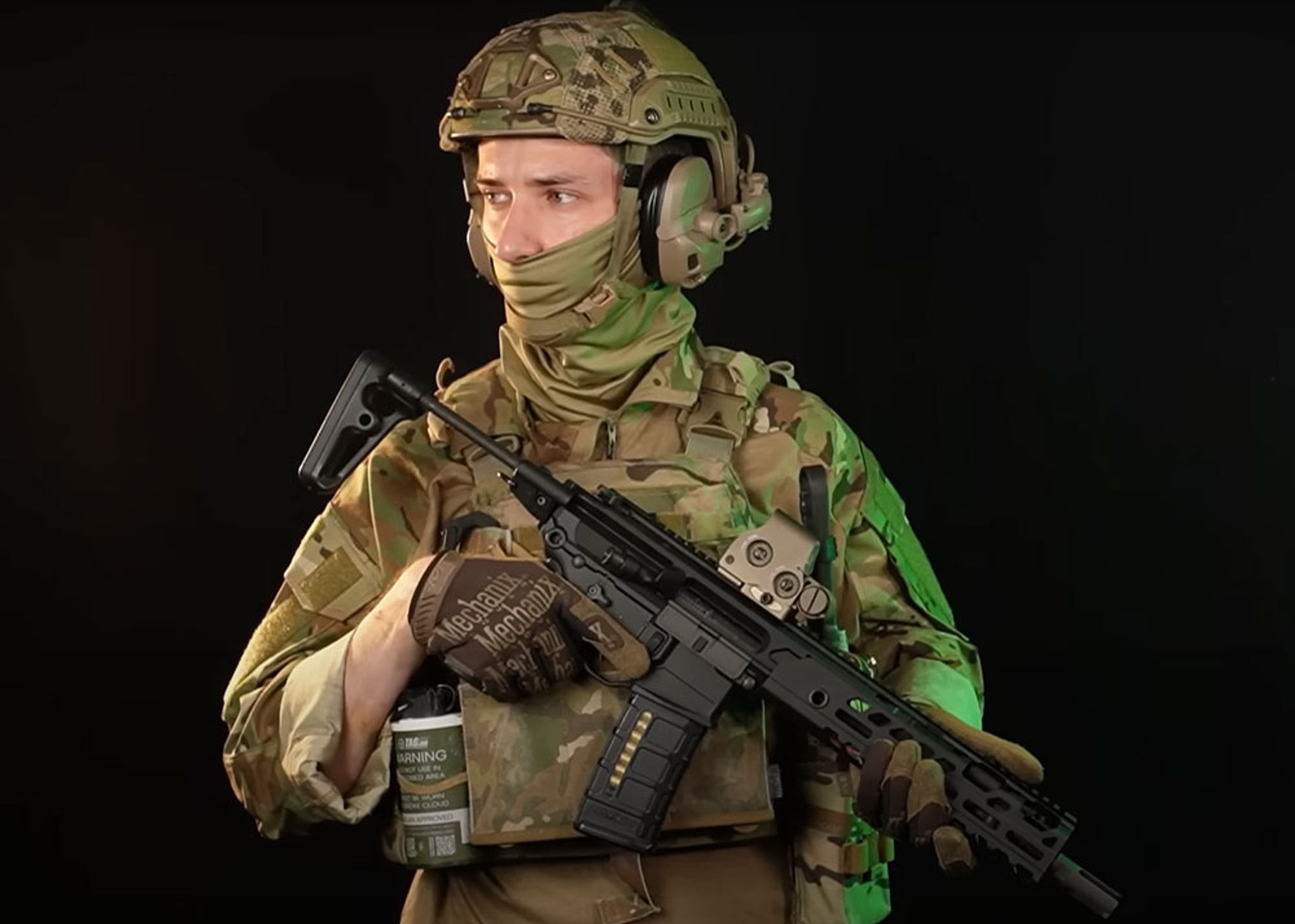 Man wearing tactical gear and clothing in multicam with the SIG Air MCX Virtus SBR airsoft rifle