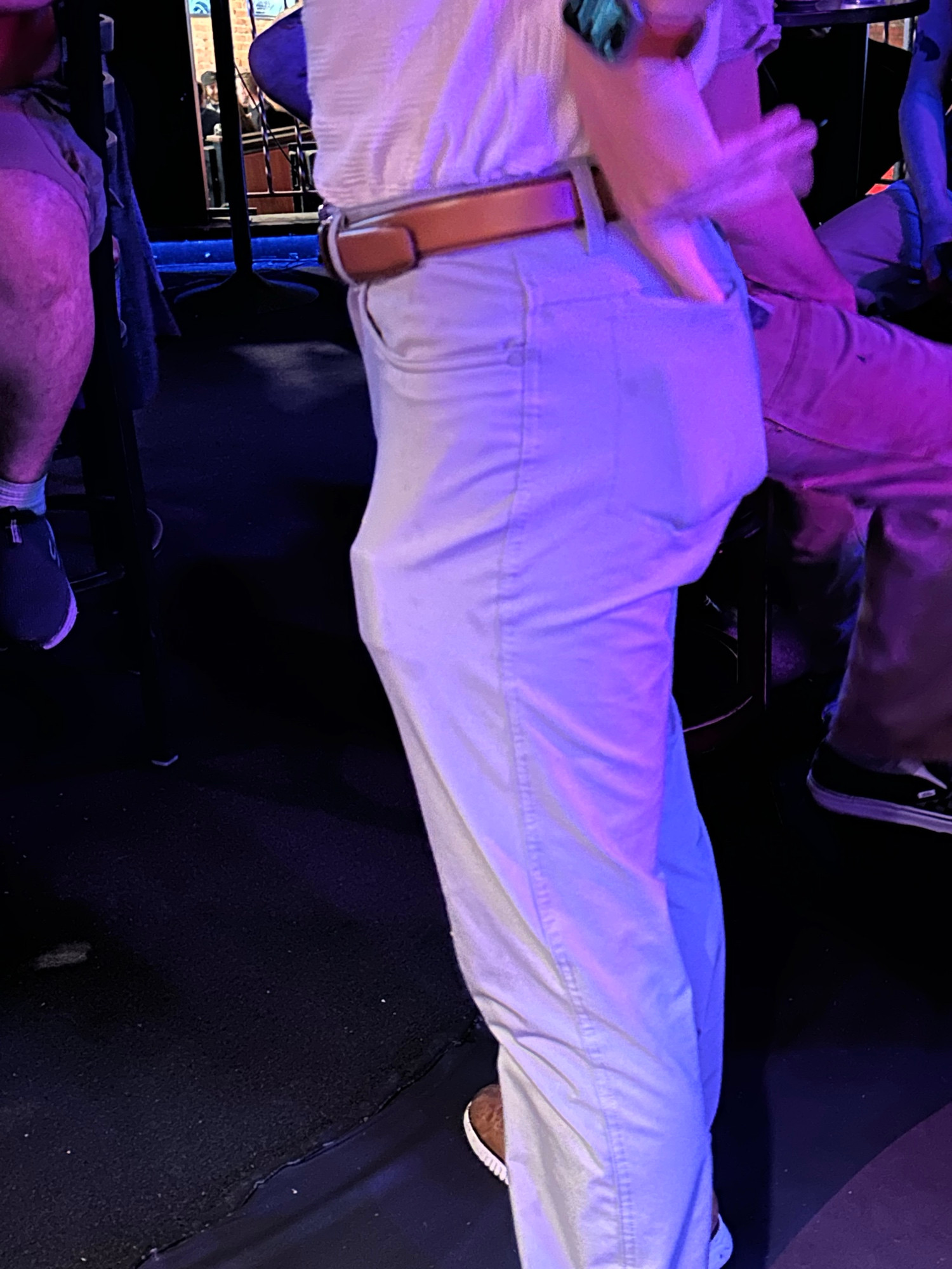 guy in very tight khaki pants with TOO much shit in his pants