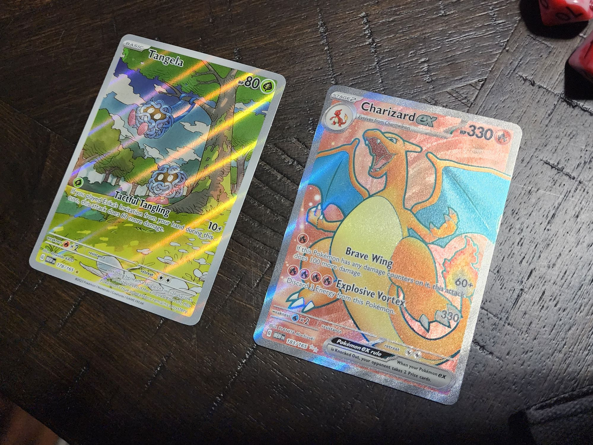 Tangela and Charizard full art cards for the Pokémon Trading Card Game.