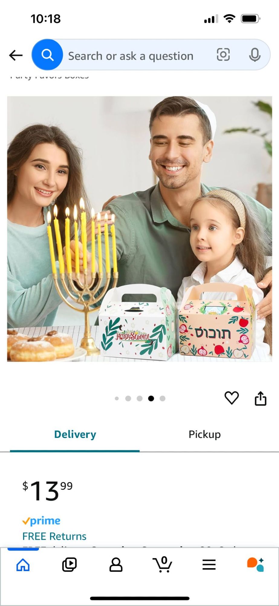 A family sits in the sukkah in front of the Tuchus boxes. On the table are delicious looking donuts and a chanukiah (chanukah menorah) with 8 candles. A young girl looks on in joy as her father lights the candles for Chanukah, which, I am compelled to note, is *also* an entirely different holiday