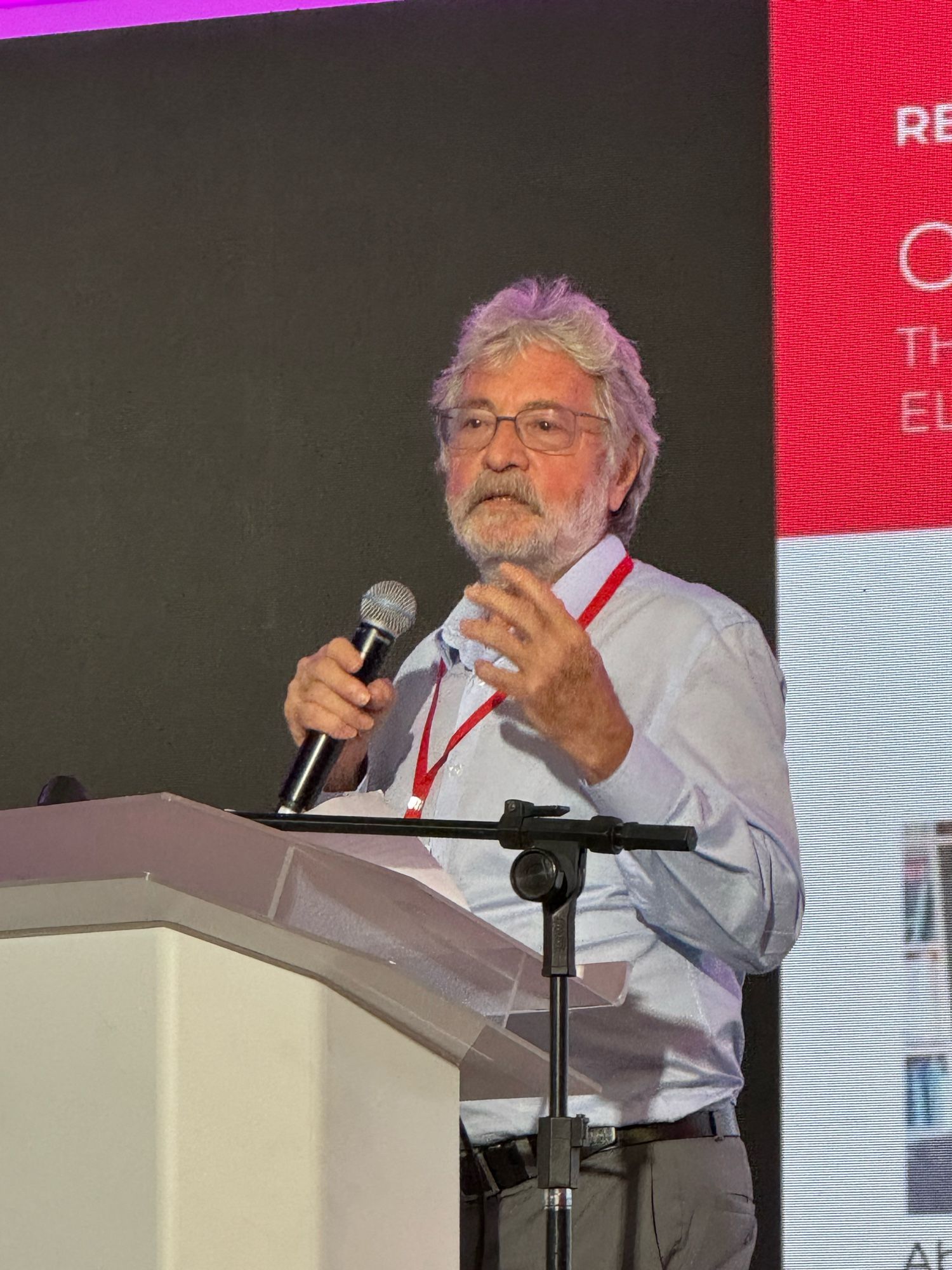 Abel Packer speaking at a podium