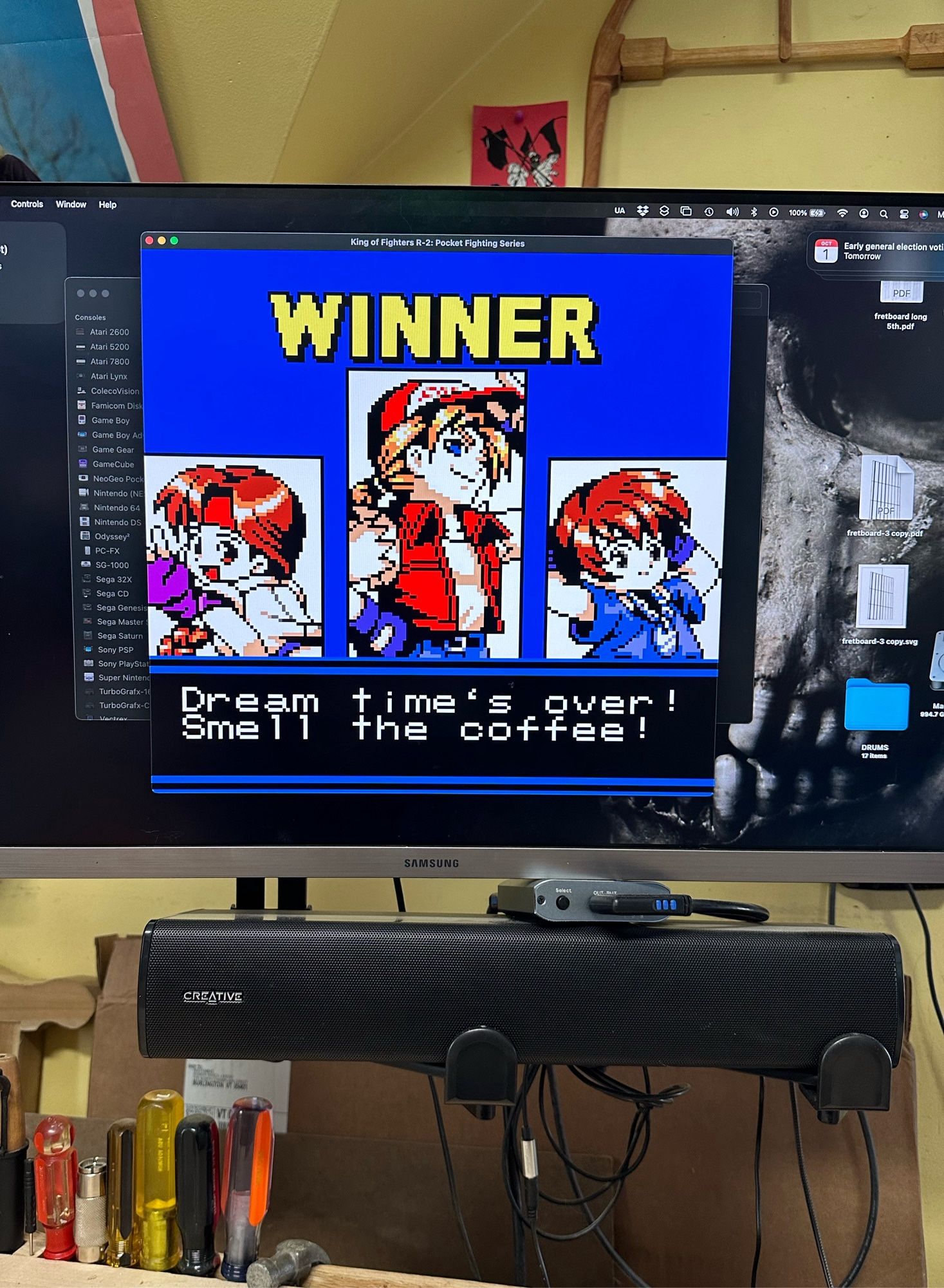 The win screen from a match of King of Fighters R2 , a NeoGeo Pocket game, on a big computer monitor. The team of Yuri, Terry and Chris just won, and it shows their character portraits. Terry’s win quote is “Dream Times over! Smell the coffee!”