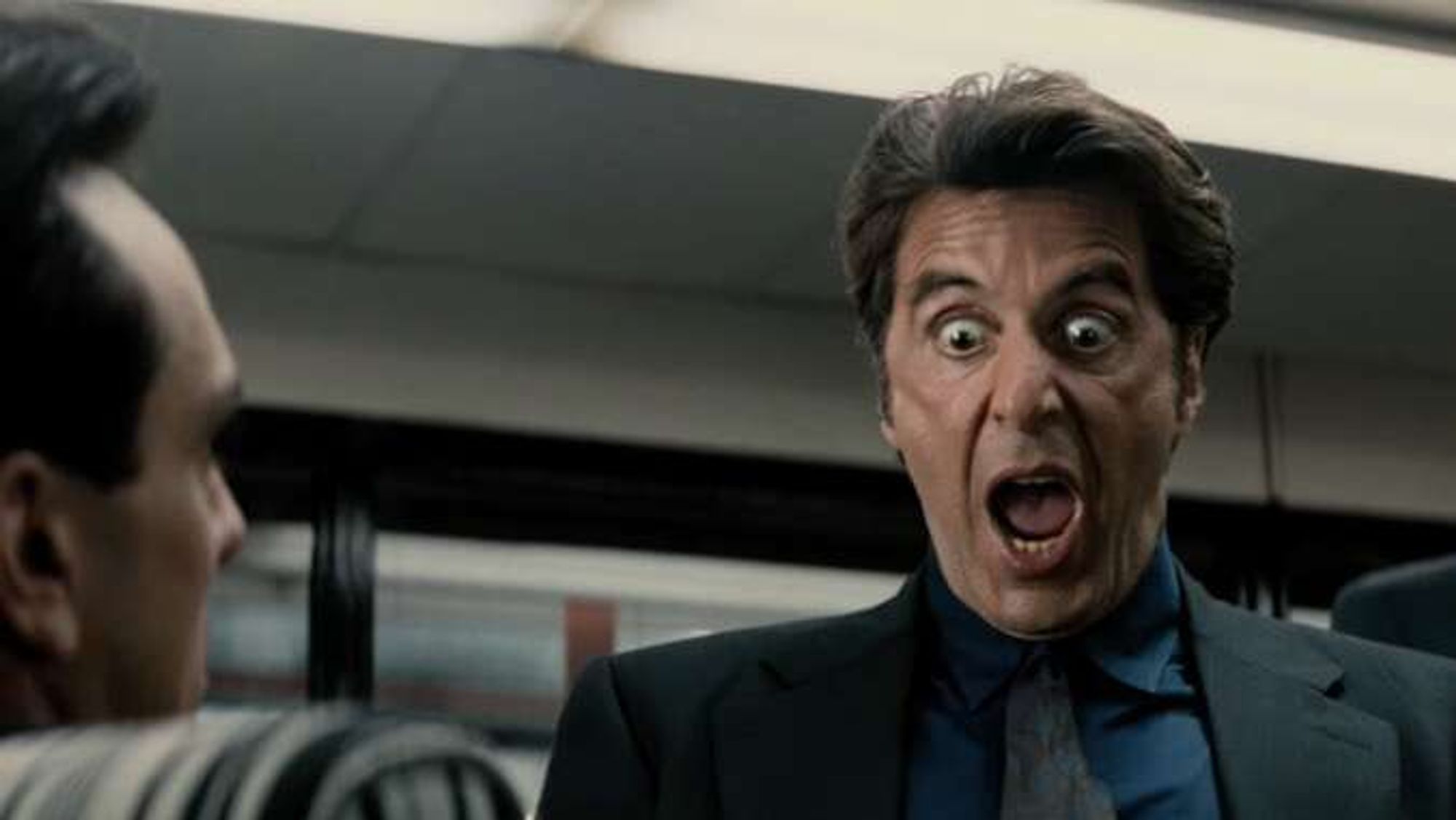 Image of Al Pacino, face contorted, delivering the "she's got a great ass" line from the movie Heat.