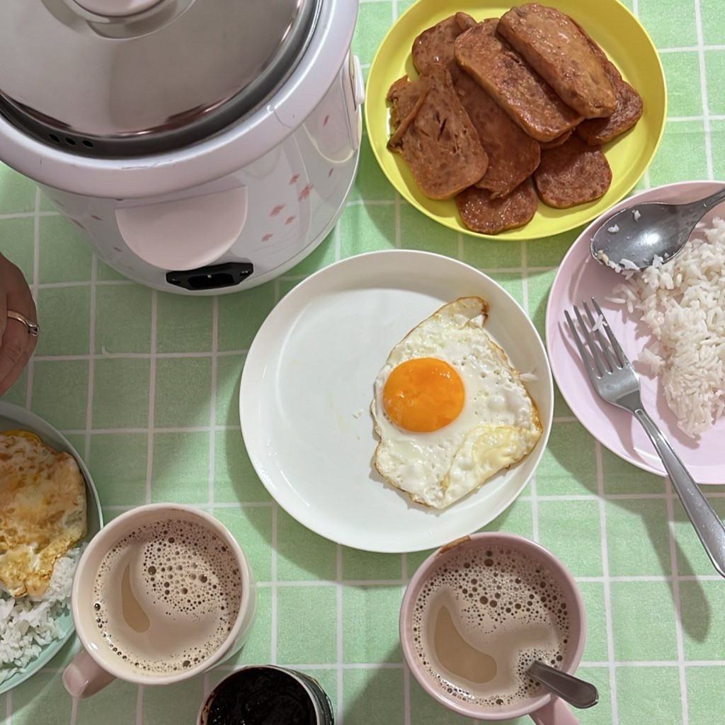 A rice cooker, two mugs of teh tarik panas, readymade sambal (I'll make my own soon, I'm still too busy), sunny-side up eggs, rice, and canned fish luncheon meat