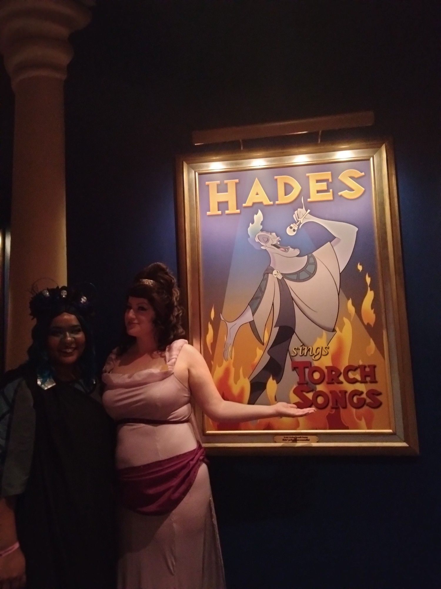 Queer couple cosplaying as Hades And Meg From Hercules at Magic Kingdome