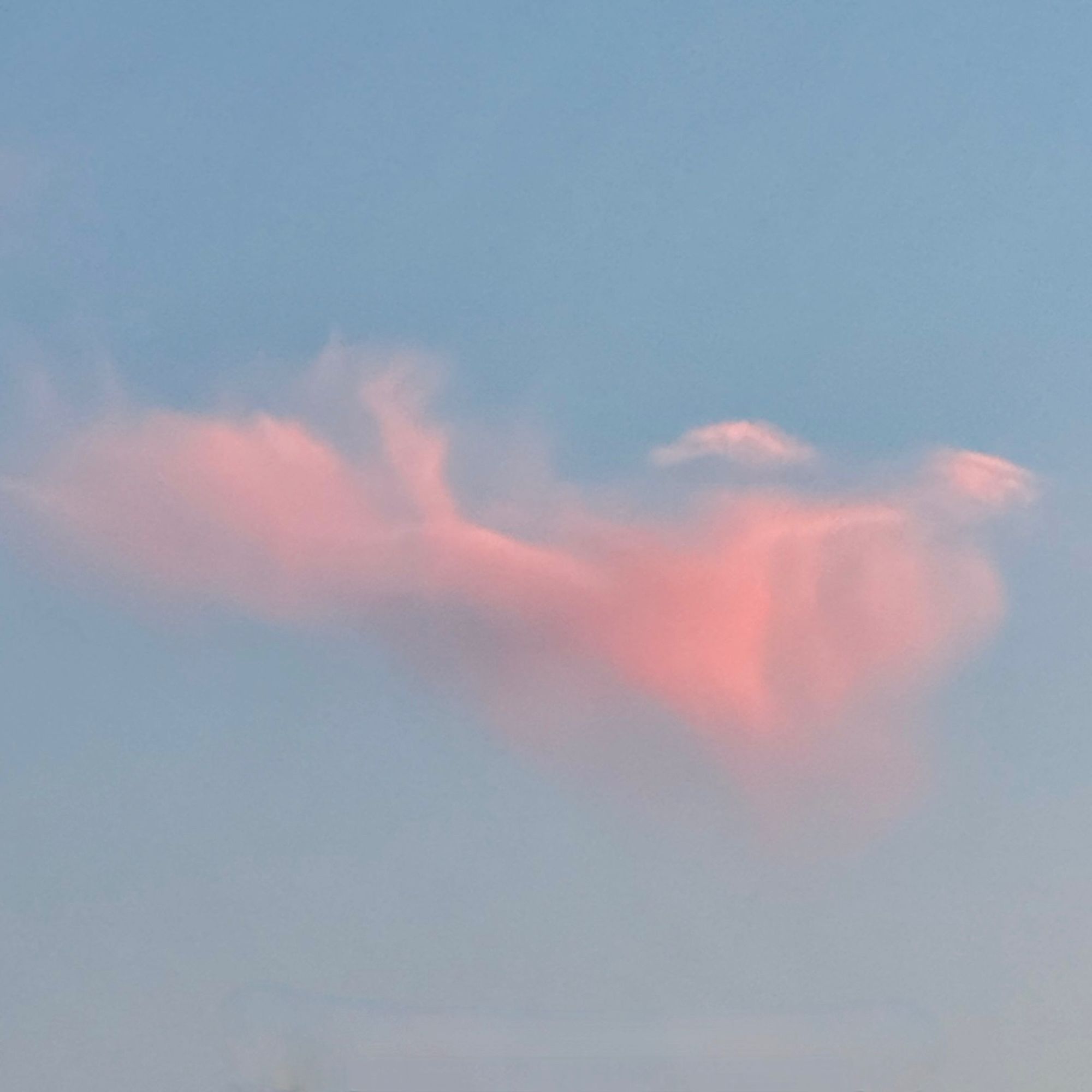 Pink cloud hovering over Oakland and the San Francisco Bay. Blue sky.