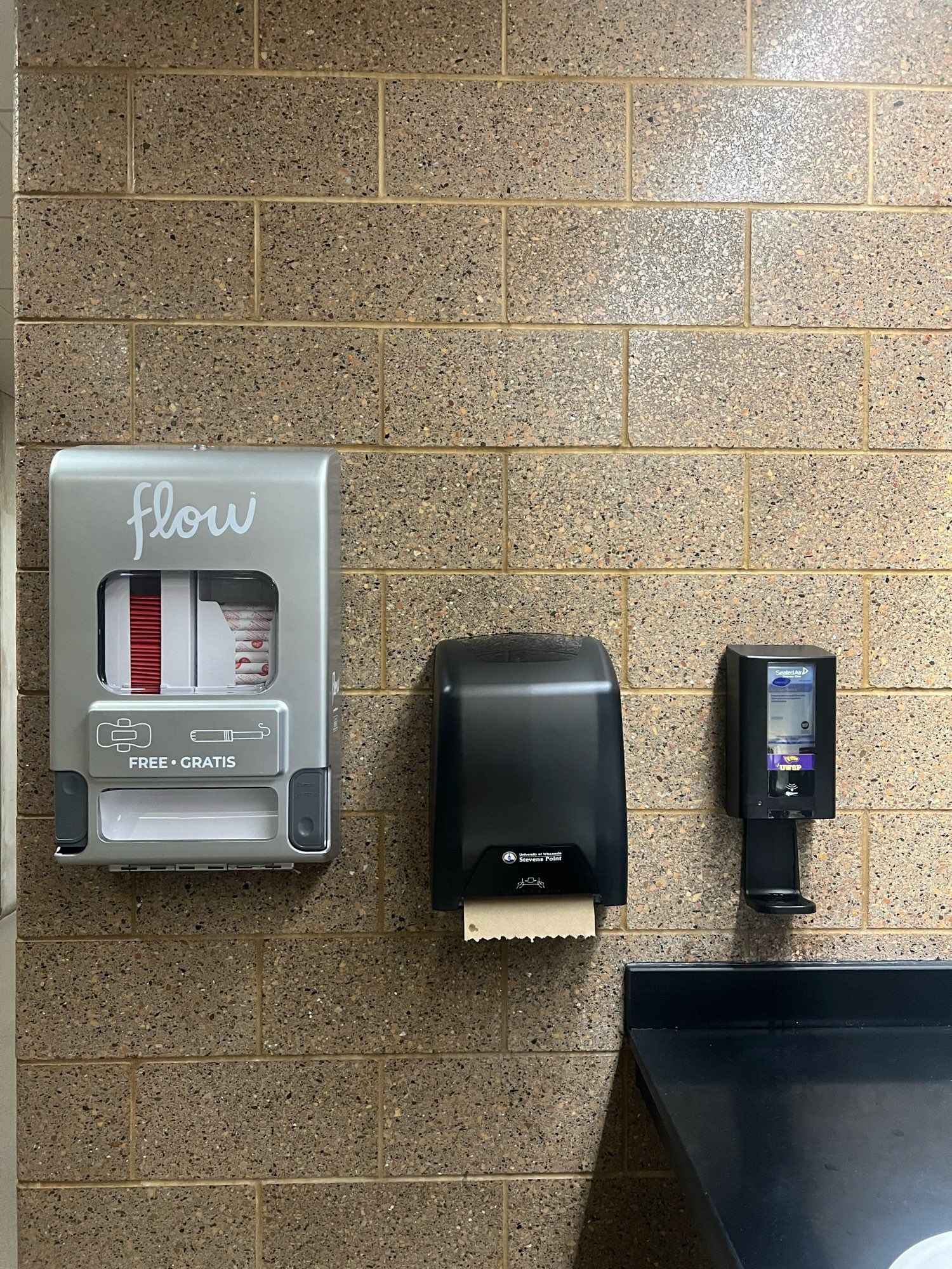 free period product , paper towel and  hand soap dispenser