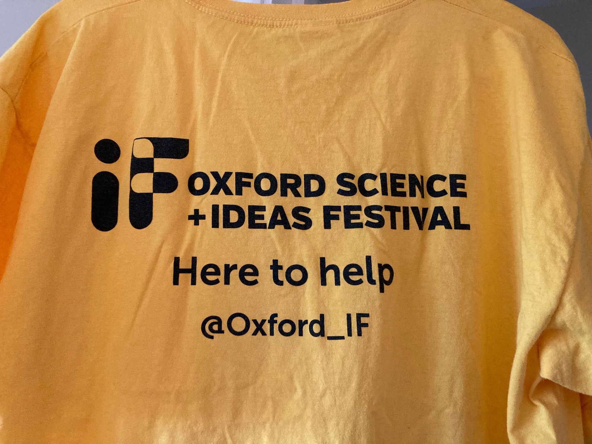 Yellow volunteer T-shirt ready to be ironed in preparation for the  IF Oxford science and ideas festival ‘here to help’