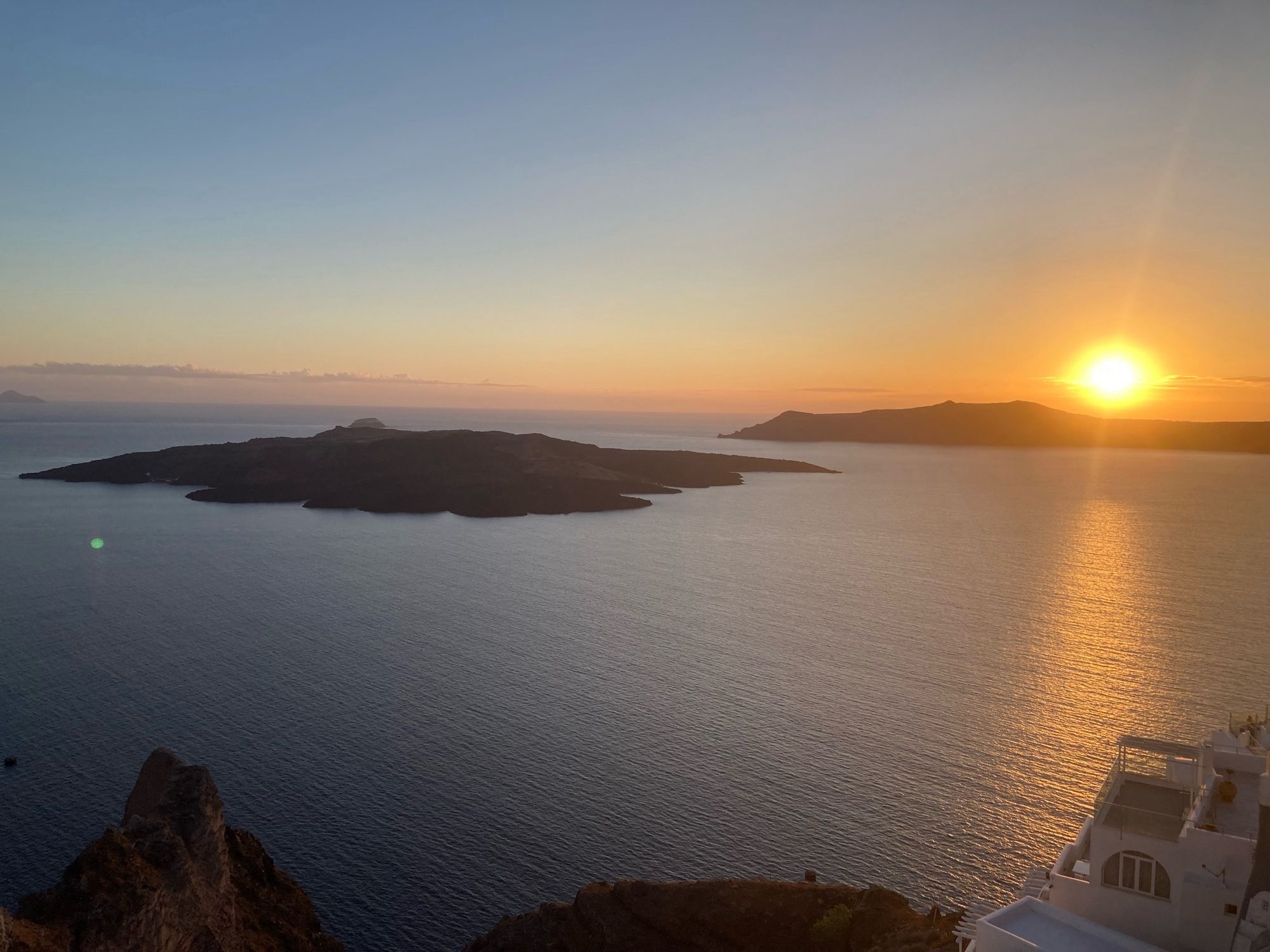 View of sunset across Therasia and the Kameni islands of Santorini Greece