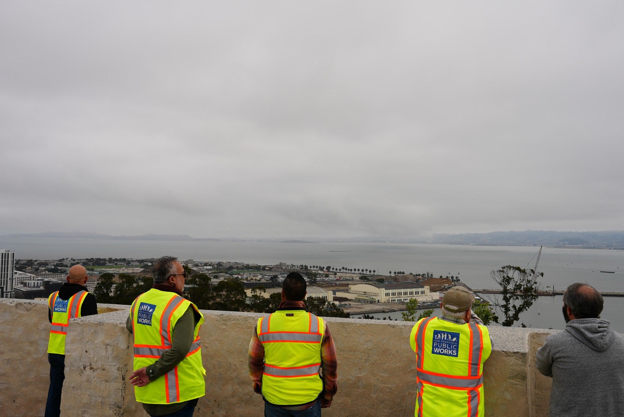 A group of Public Works trades workers takes in the view of Treasure Island during a tour of new parks that they'll help maintain.