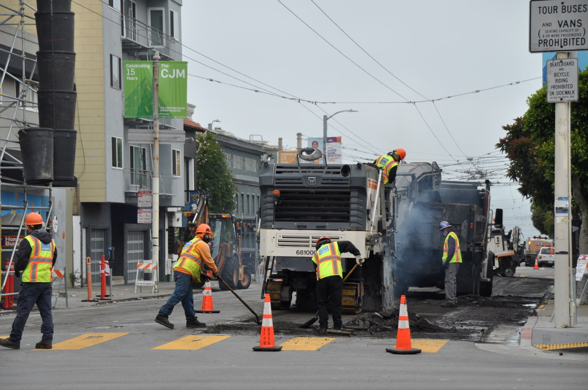 Public Works’ street repair crews, using heavy machinery, work on a paving job in the Marina.