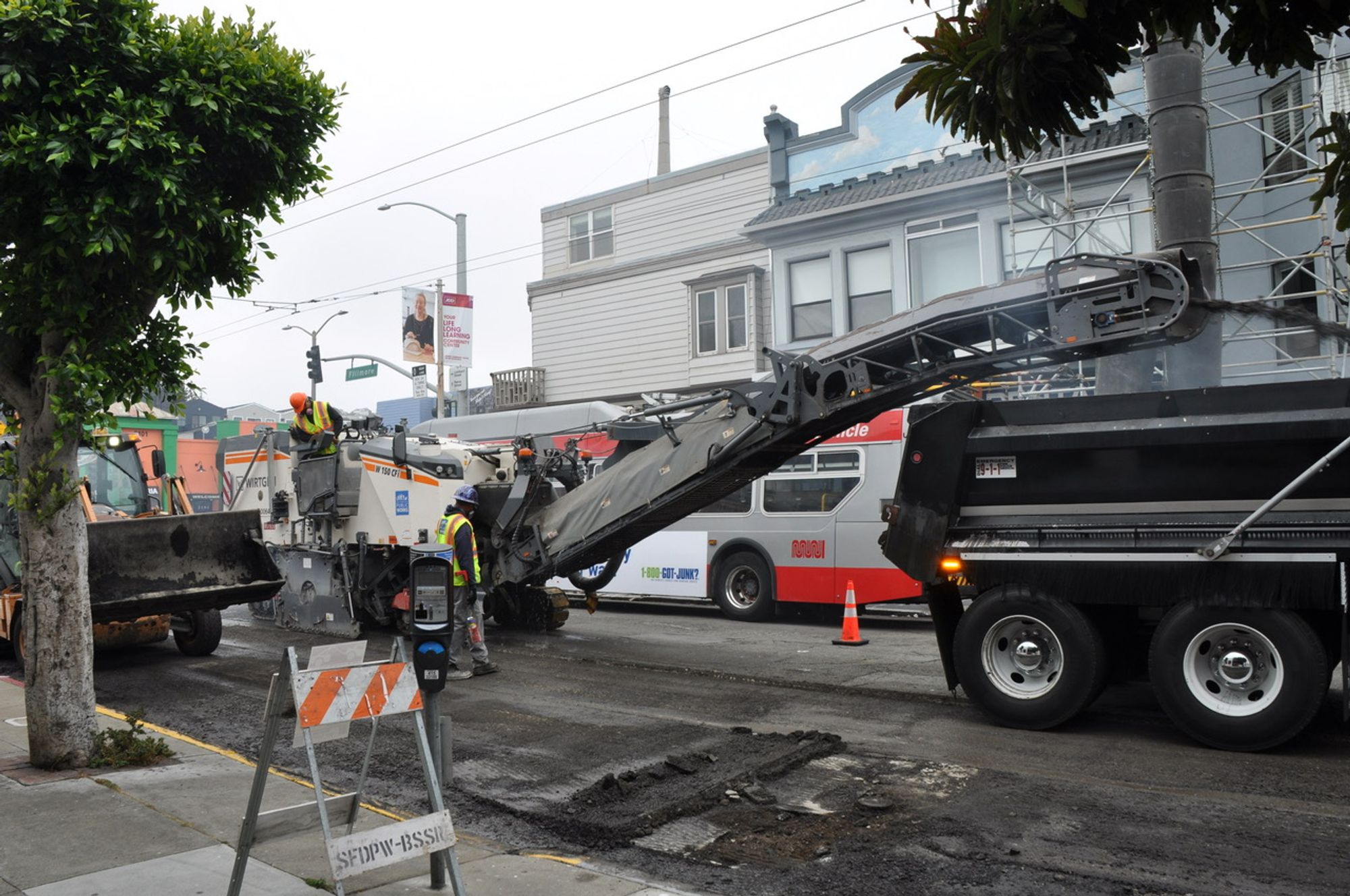 Public Works’ street repair crews, using heavy machinery, work on a paving job in the Marina.