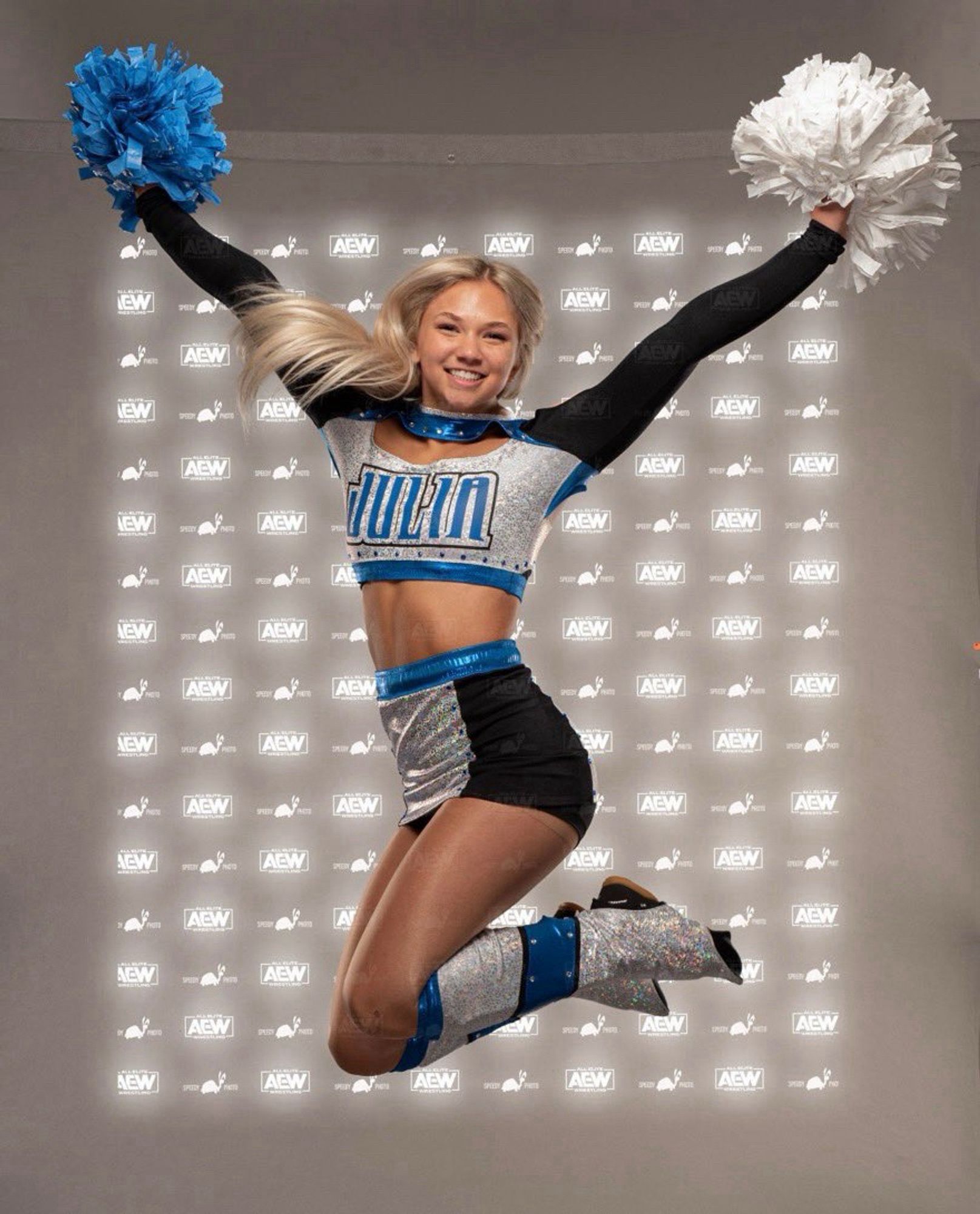 Julia Hart in a cheerleader uniform as part of her former varsity blondes gimmick