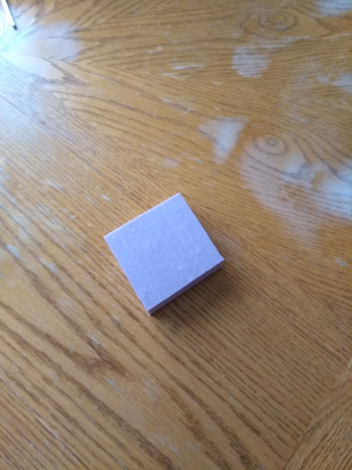 A small square of pink insulation foam, sitting by itself on my table. Waiting to be carved into a dungeon tile.