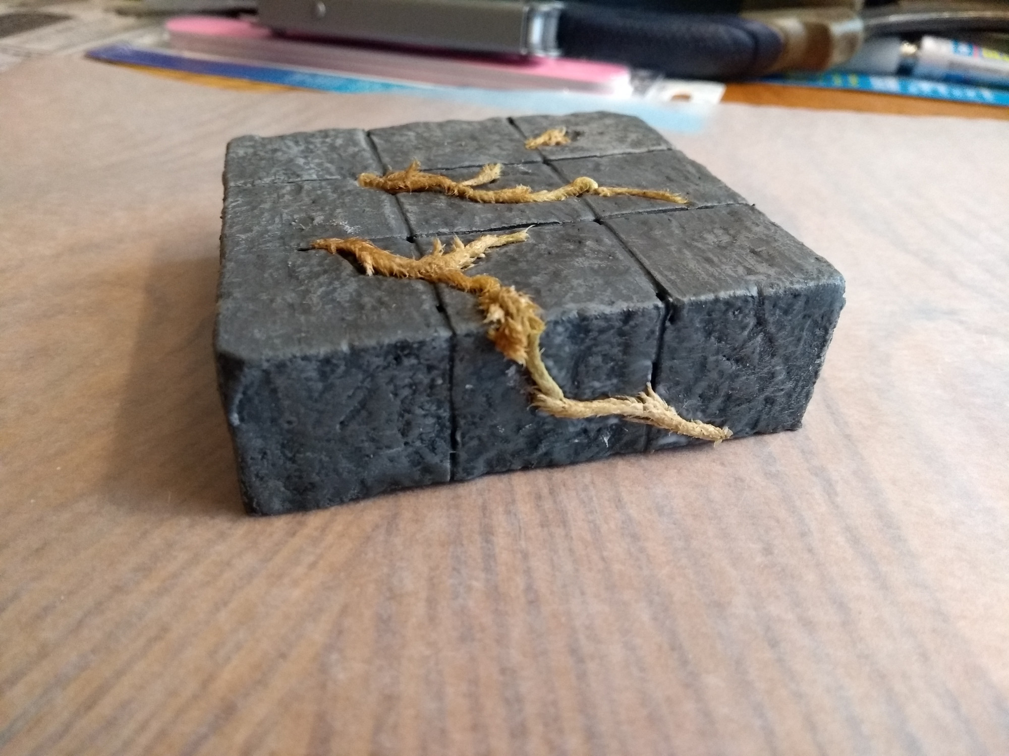 Side view of the dungeon tile, showing that the sides are also painted, textured and disrupted by the moss.