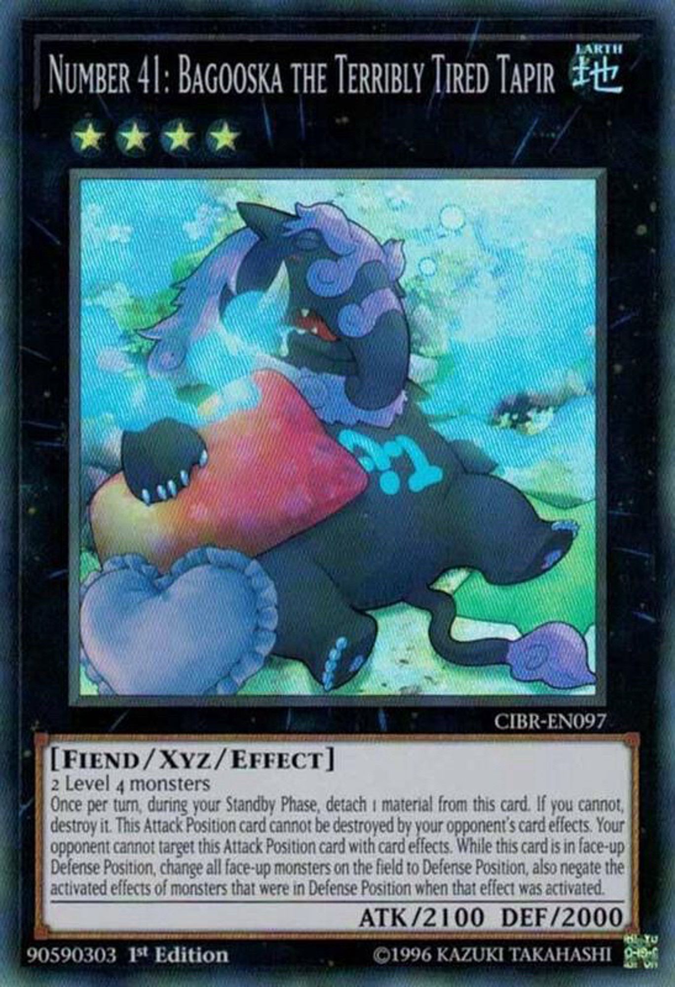 A Yugioh card called Bagooska the Terribly Tired Tapir featuring a tapir lying in a bunch of pillows