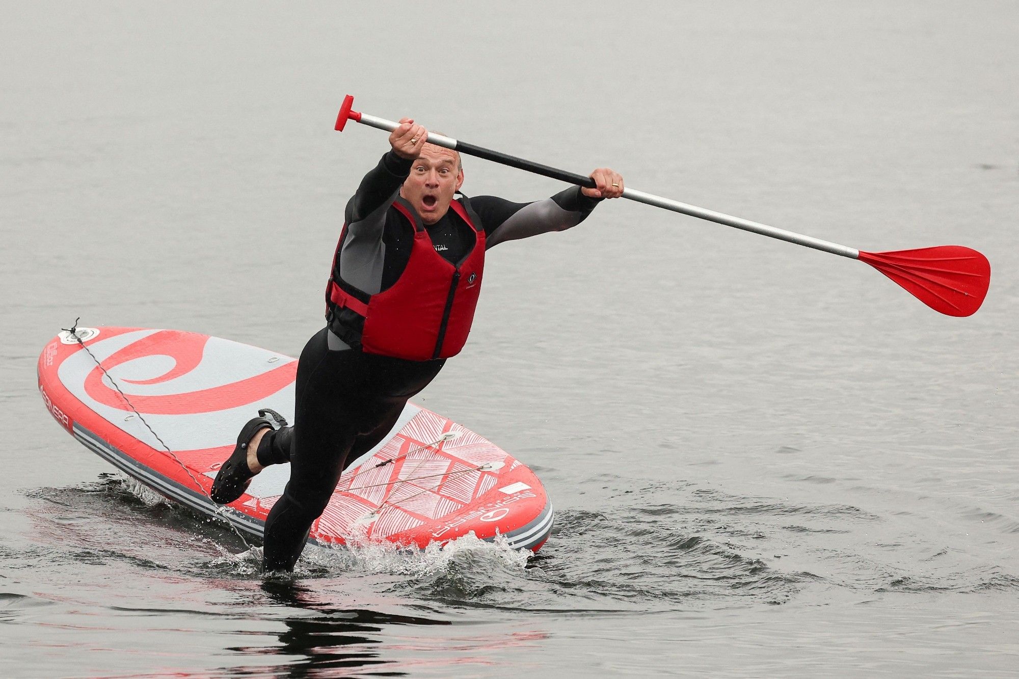 Ed Davey falls into a lake.