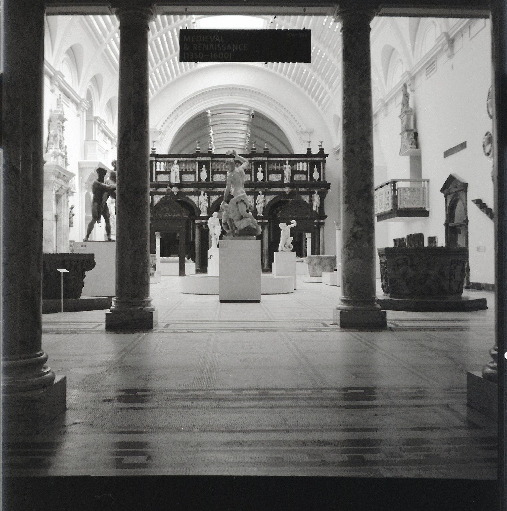 View of a gallery full of statues but empty of people at the V&A