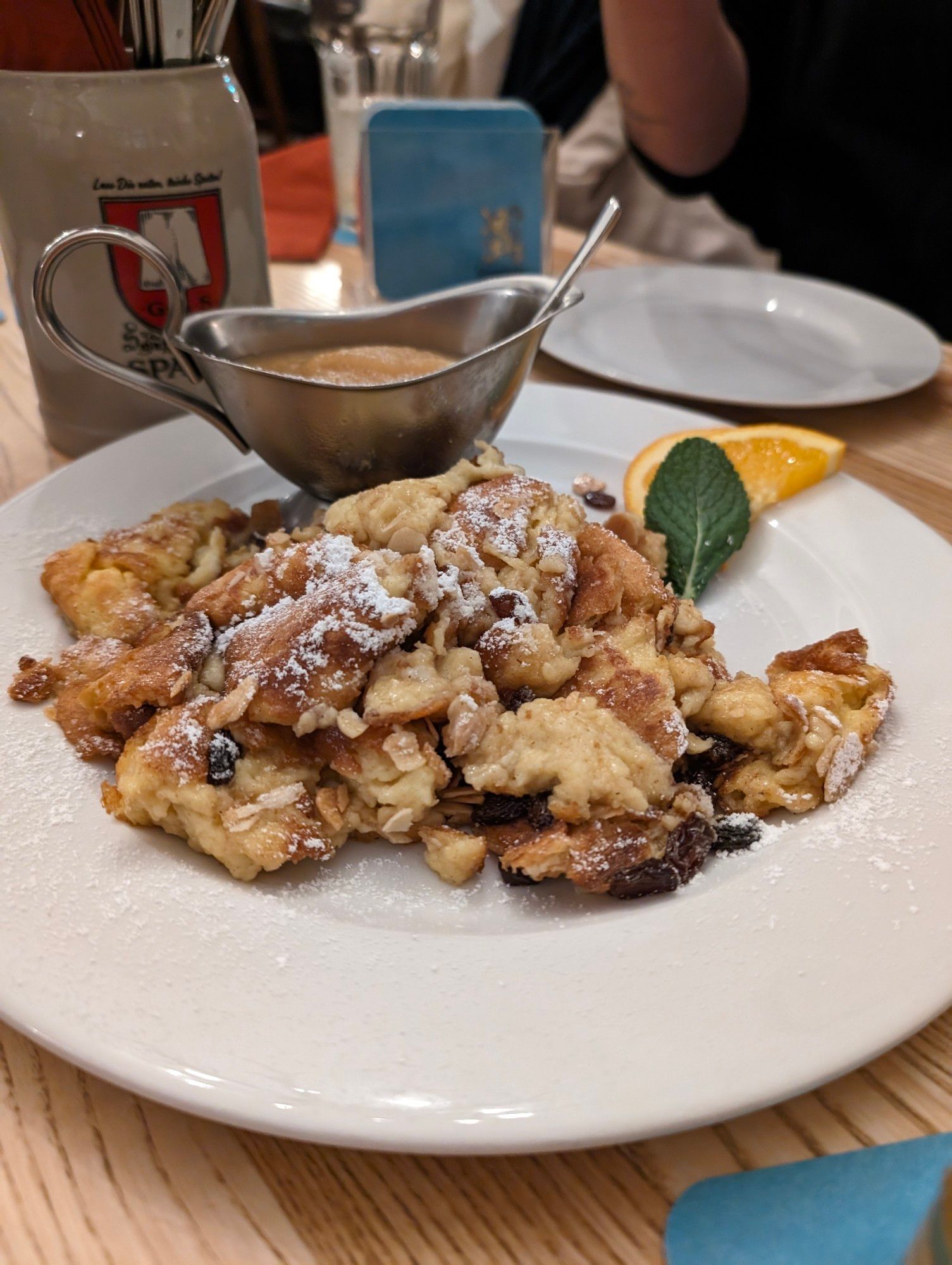 Ein Teller mit Kaiserschmarrn und einer Sauniere mit Apfelmus