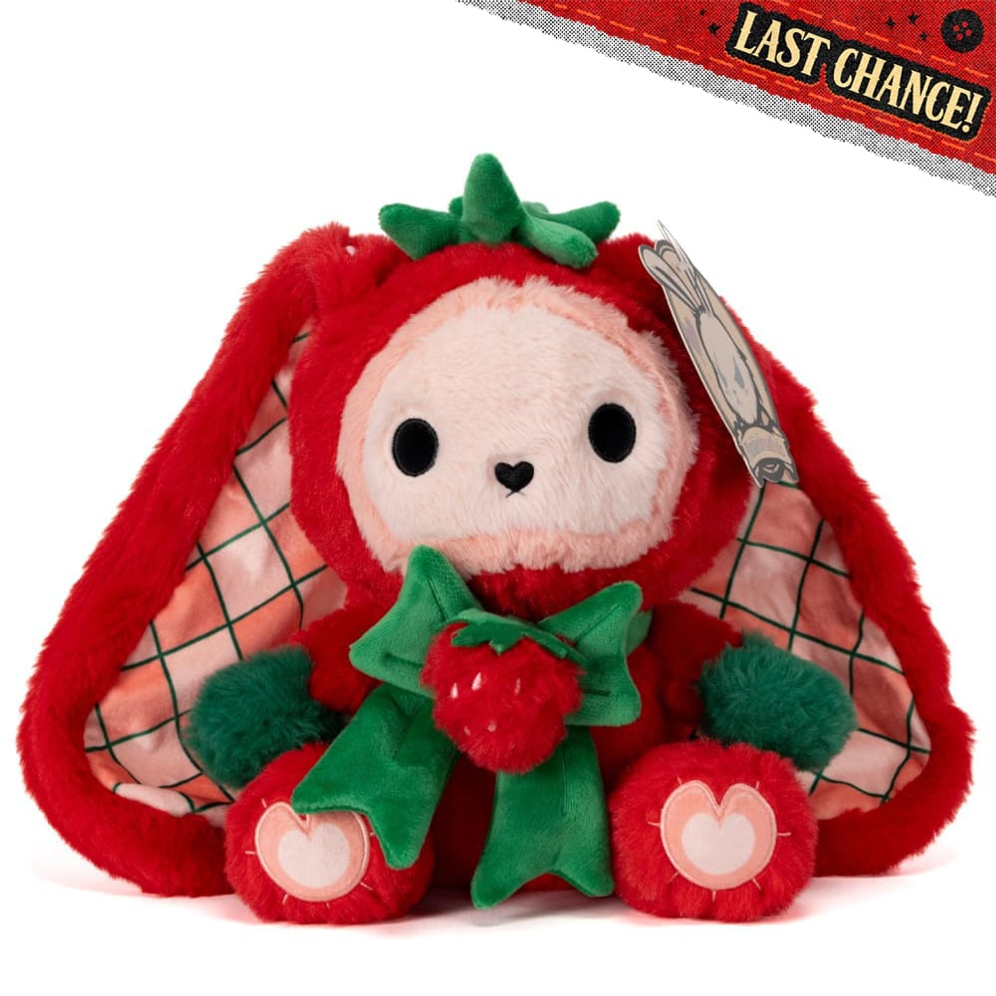 strawbunny!!! the inside of its ears are plaid and it looks like its wearing a little strawberry cap around its head and it has a strawberry bow like kuroame!!