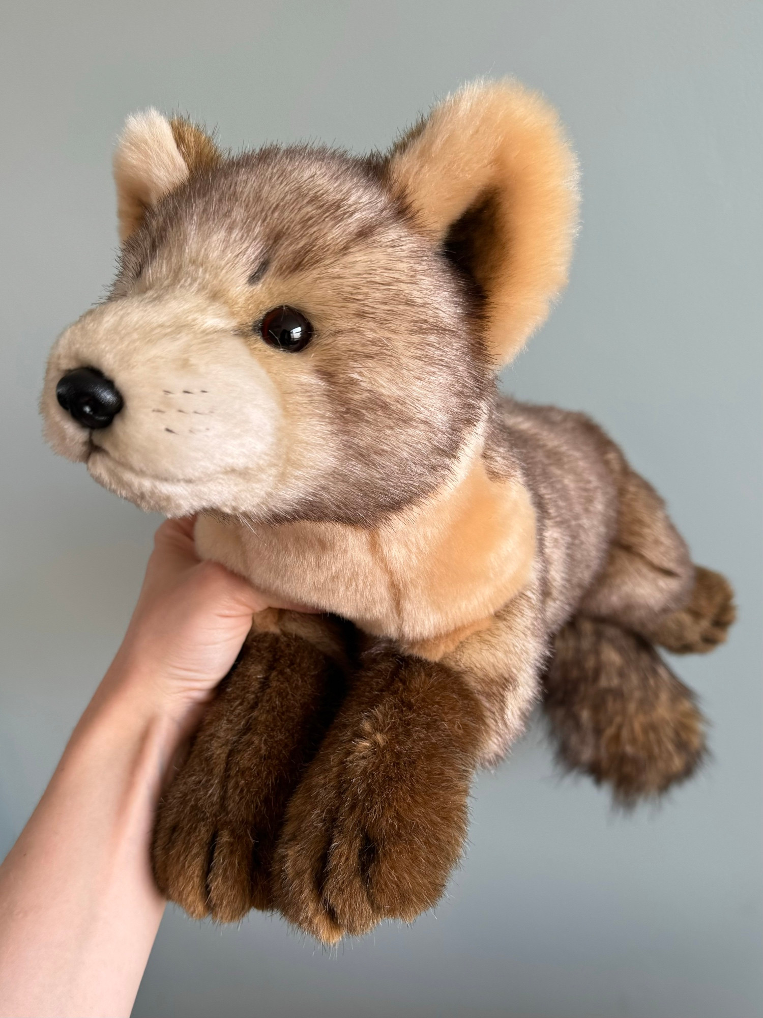 Photo of a handmade plush pine marten seen looking to the left in 3/4. 