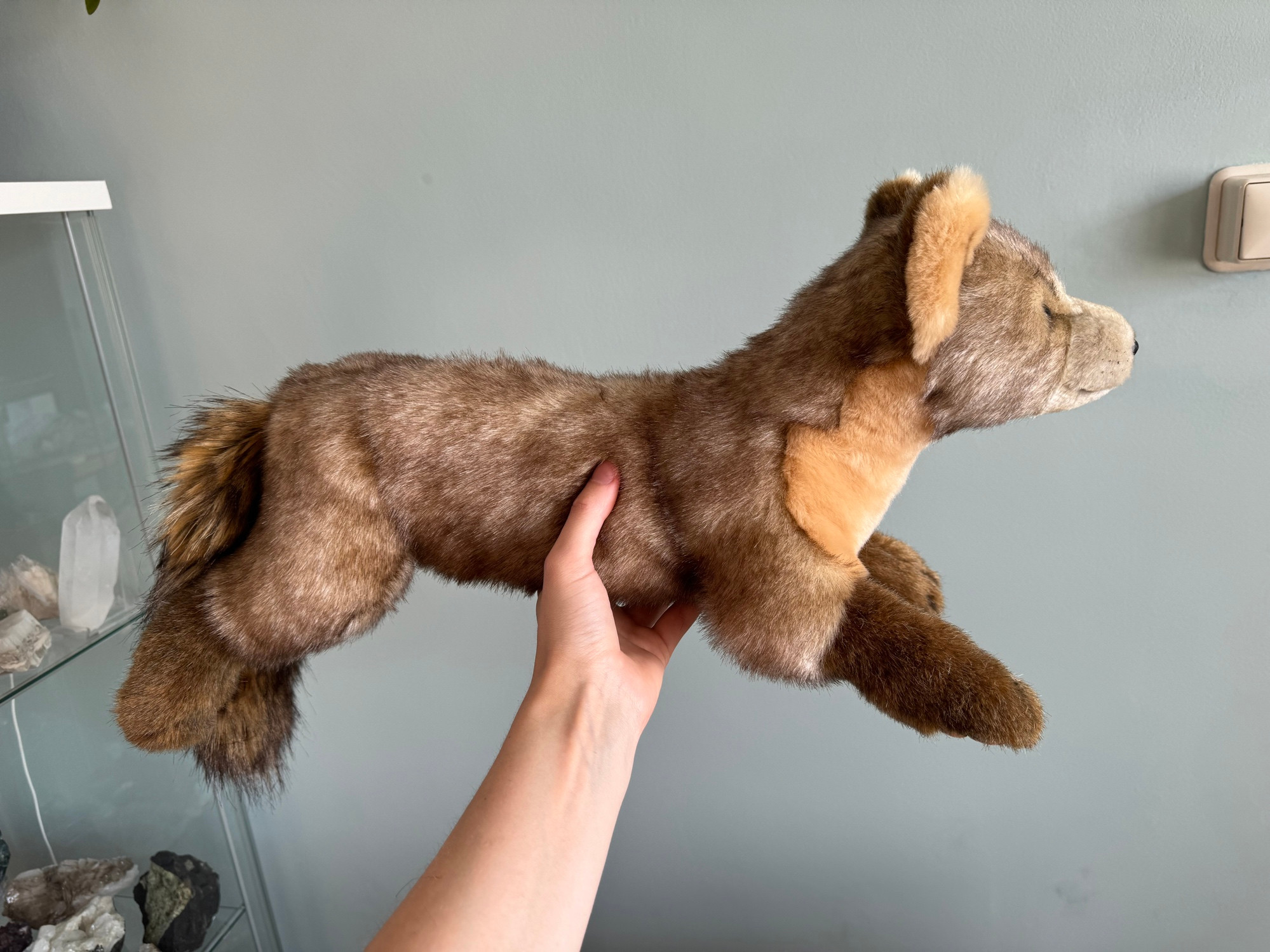 Photo of a handmade plush pine marten seen from the side