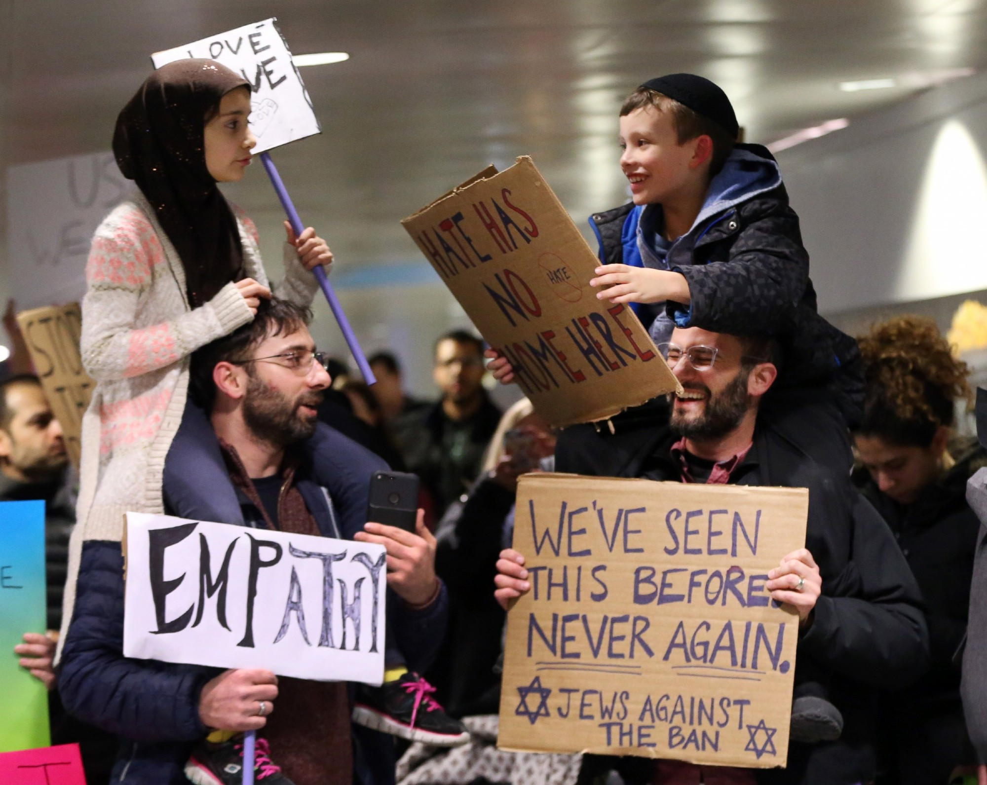 Meryem Yildirim, 7, left, sits on the shoulders of her father, Satih, of Schaumburg, and Adin Bendat-Appell, 9, right, sits on the shoulders of his father, Rabbi Jordan Bendat-Appell, of Deerfield, during a protest, on Jan. 30, 2017 at O'Hare International Airport in Chicago.

Nuccio DiNuzzo/Chicago Tribune/TNS via Getty Images