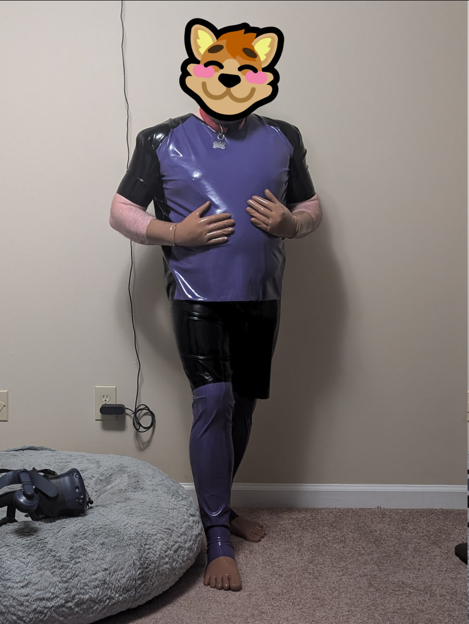 IRL me wearing purple and black rubber and a red nylon collar with a bone tag. There's a blush sticker over my face. I've also got brown rubber gloves and socks on with purple leggings.