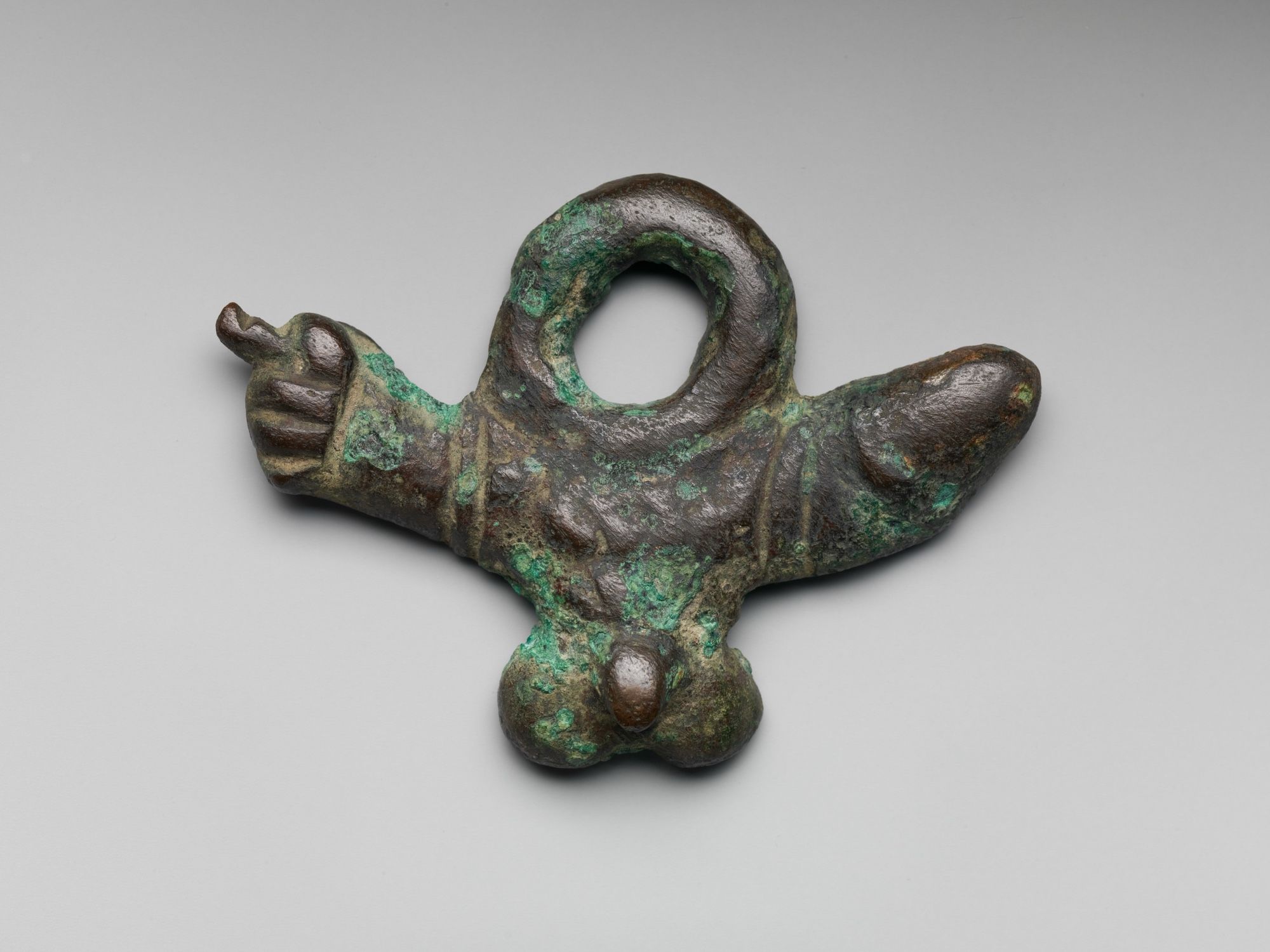 Description from the Met museum: “Bronze phallic amulet; Roman; 1st century CE. This amulet incorporates three different symbols: the phallus, male genitalia, and the mano fica (a rude hand gesture). All three were potent apotropaic devices intended to ward off the Evil Eye.”