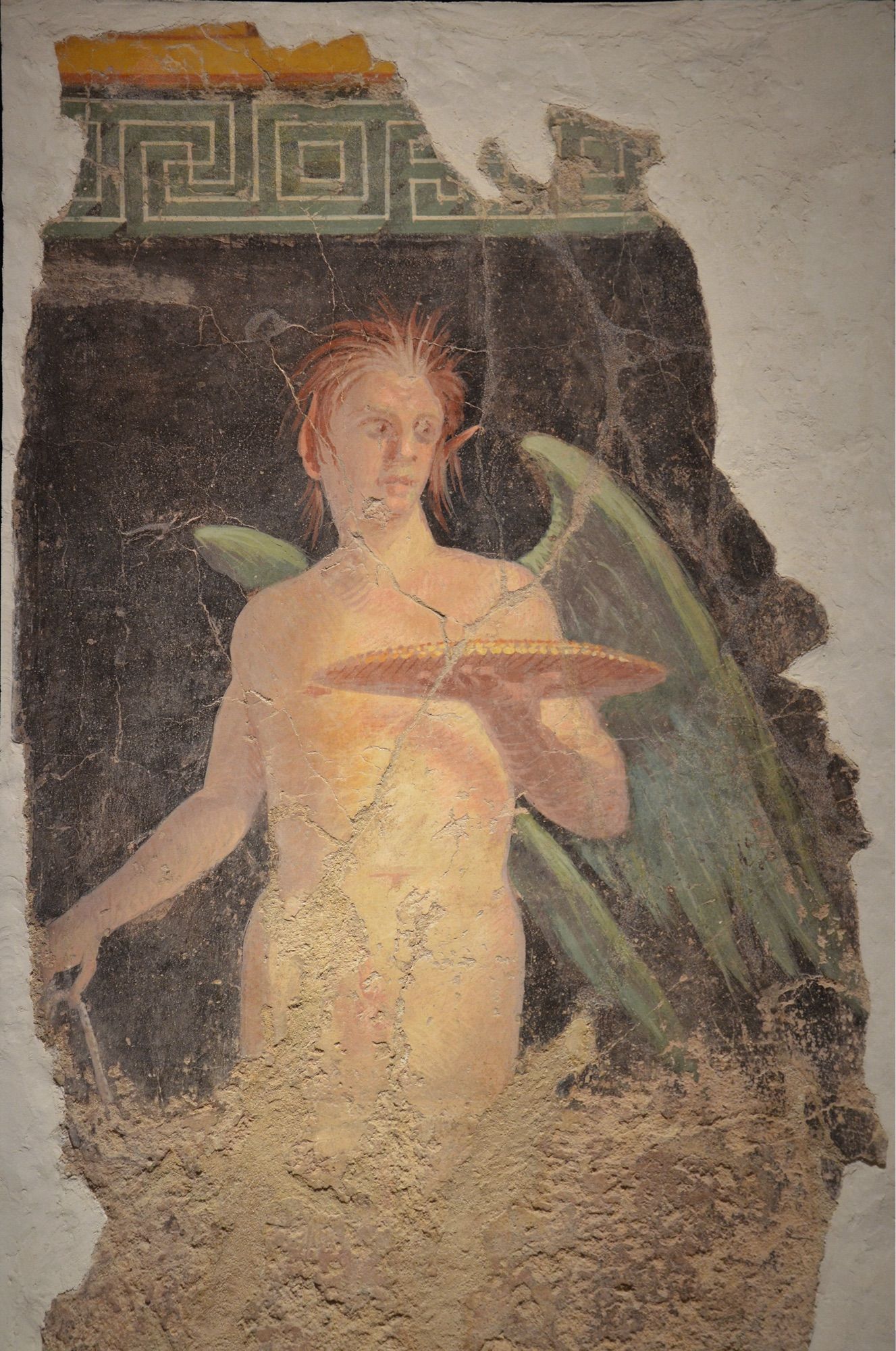 Description from World History Encyclopaedia: “Fresco depicting a winged genius holding a patera (sacrificial dish), from the north wall of the peristyle of Villa of P. Fannius Synistor at Boscoreale, 4030 BC, Empire of colour. From Pompeii to Southern Gaul, Musée Saint-Raymond Toulouse © Carole Raddato.”