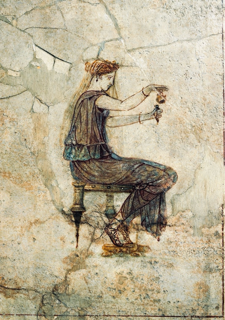 A woman is depicted seated on a chair pouring liquid from a small jug into a smaller vessel. She wears a nearly transparent veil over her hair and has criss-crossed laced shoes.